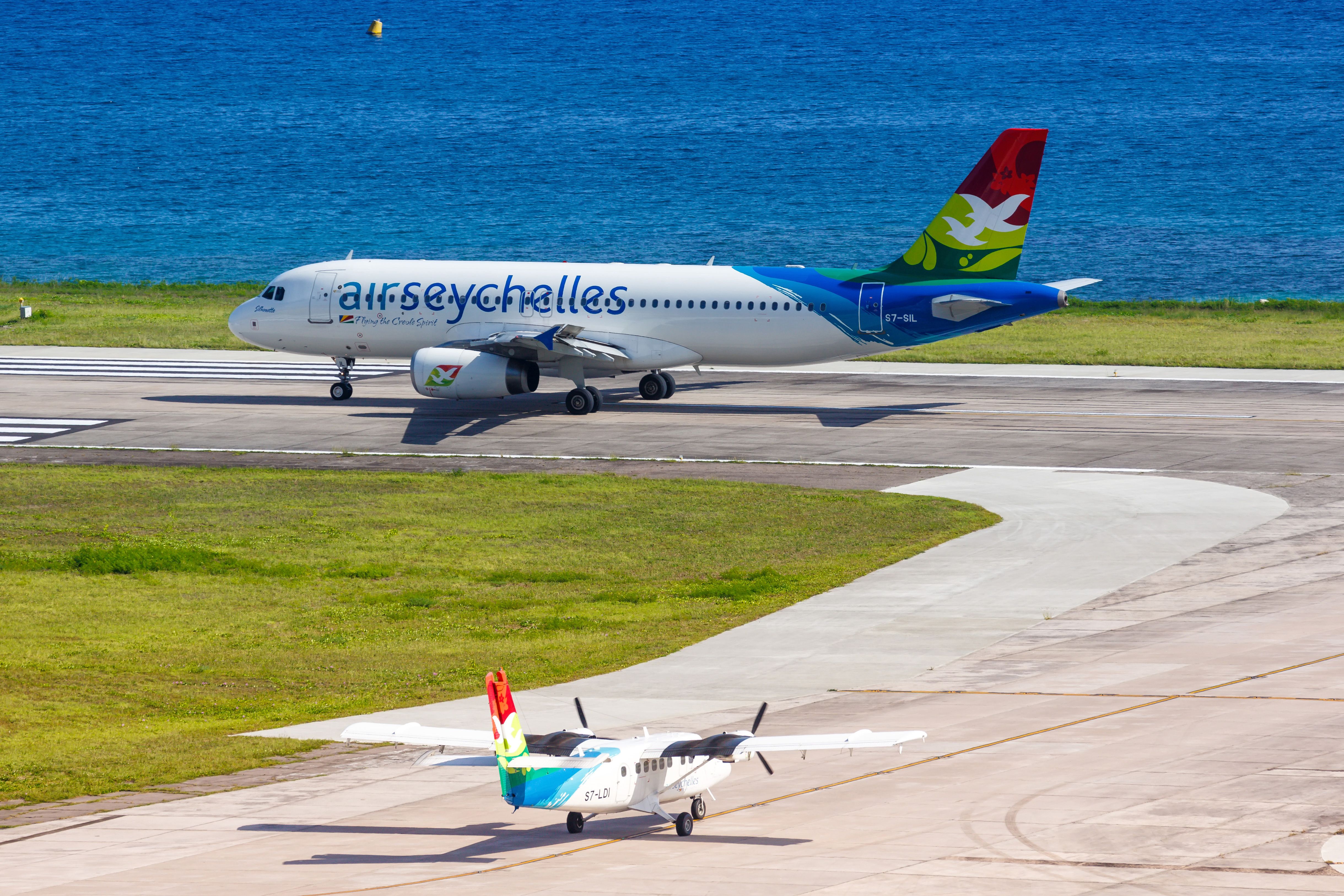 Air Seychelles A320 on the runway, as another Air Seychelles aircraft waits to enter the runway
