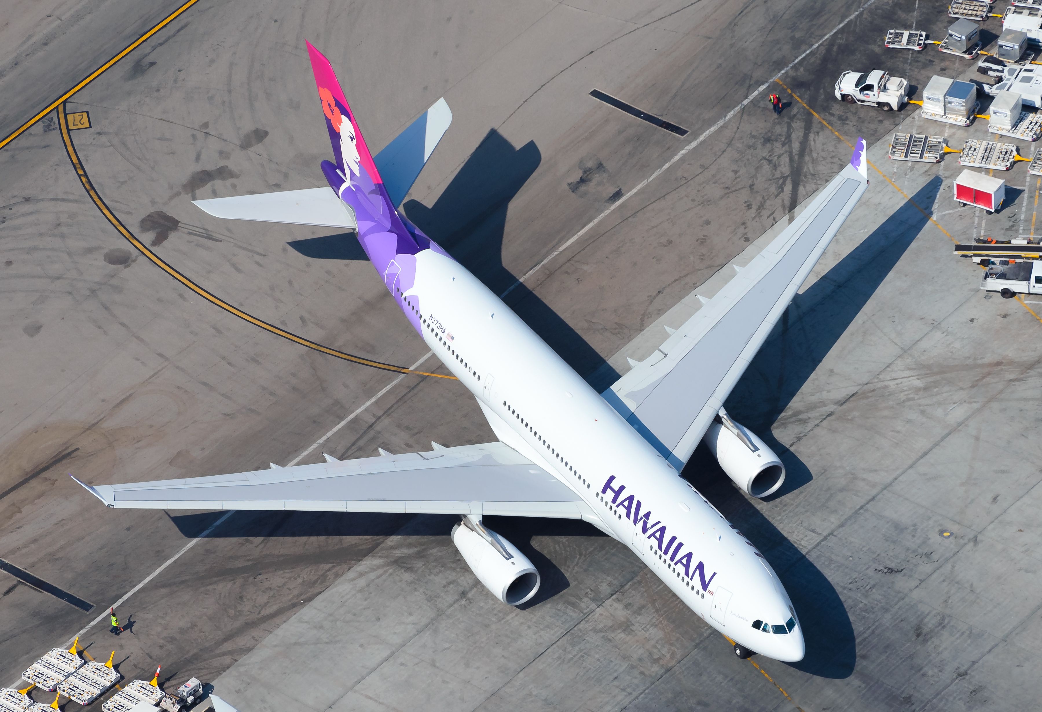 Aerial view of Hawaiian Airlines Airbus A330 taxiing at an airport.