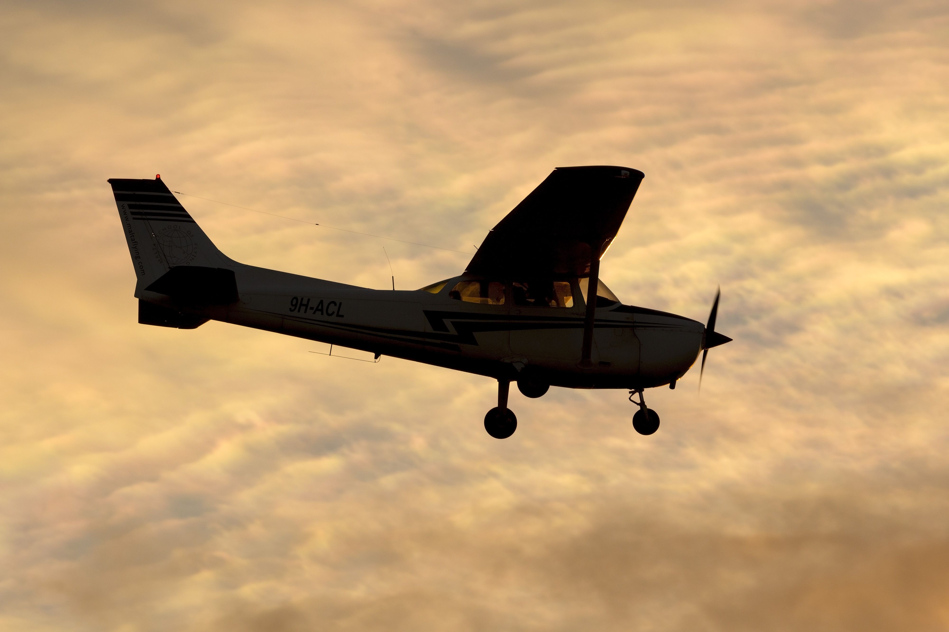 A Cessna 172 Skyhawk flying during sunset.