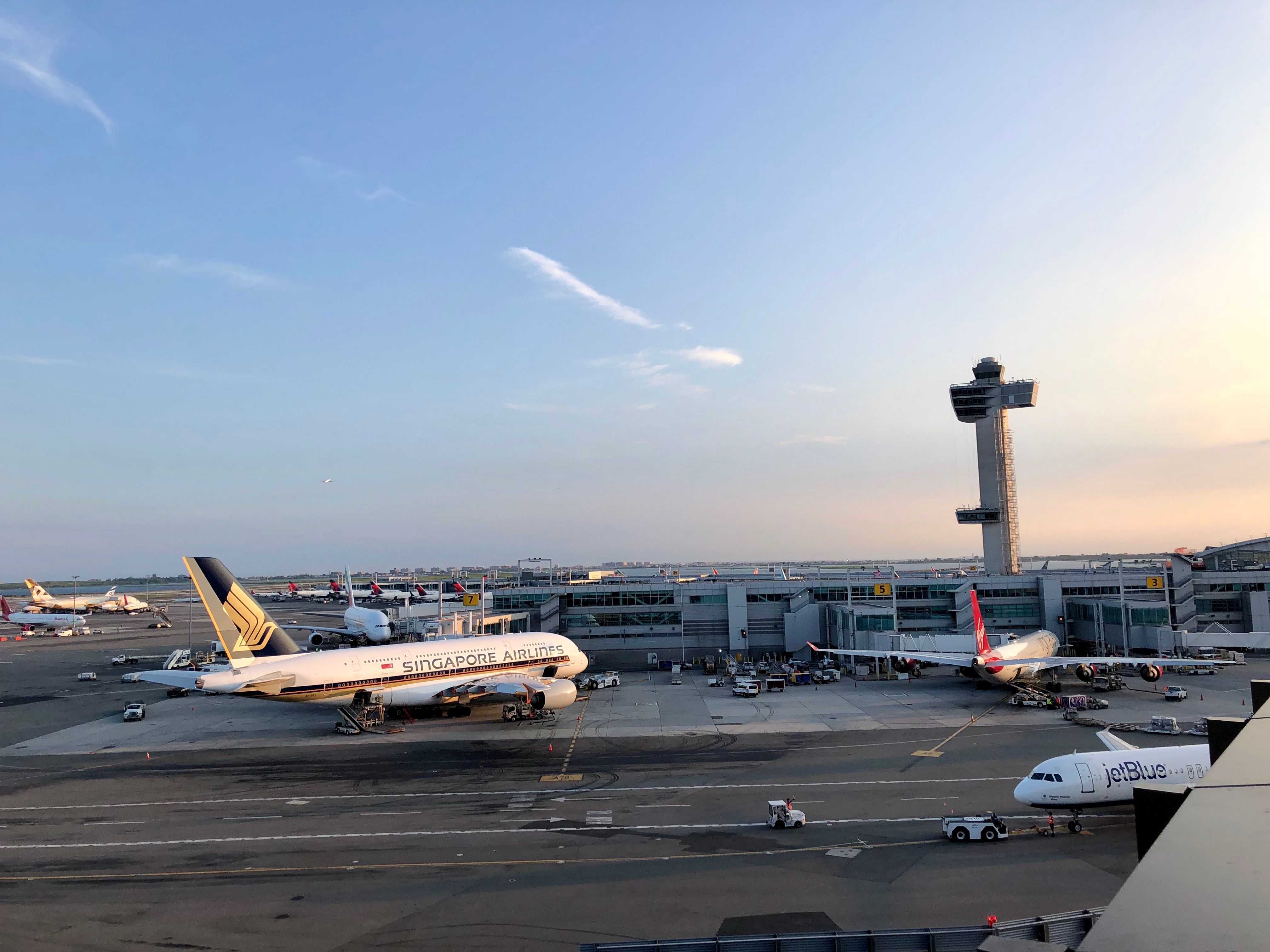 A panoramic view of New York JFK Airport's apron, with a Singapore Airlines aircraft being loaded.