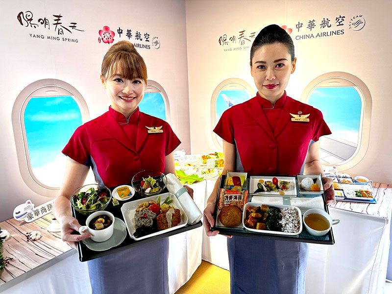 China airlines cabin crew holding meal trays. 