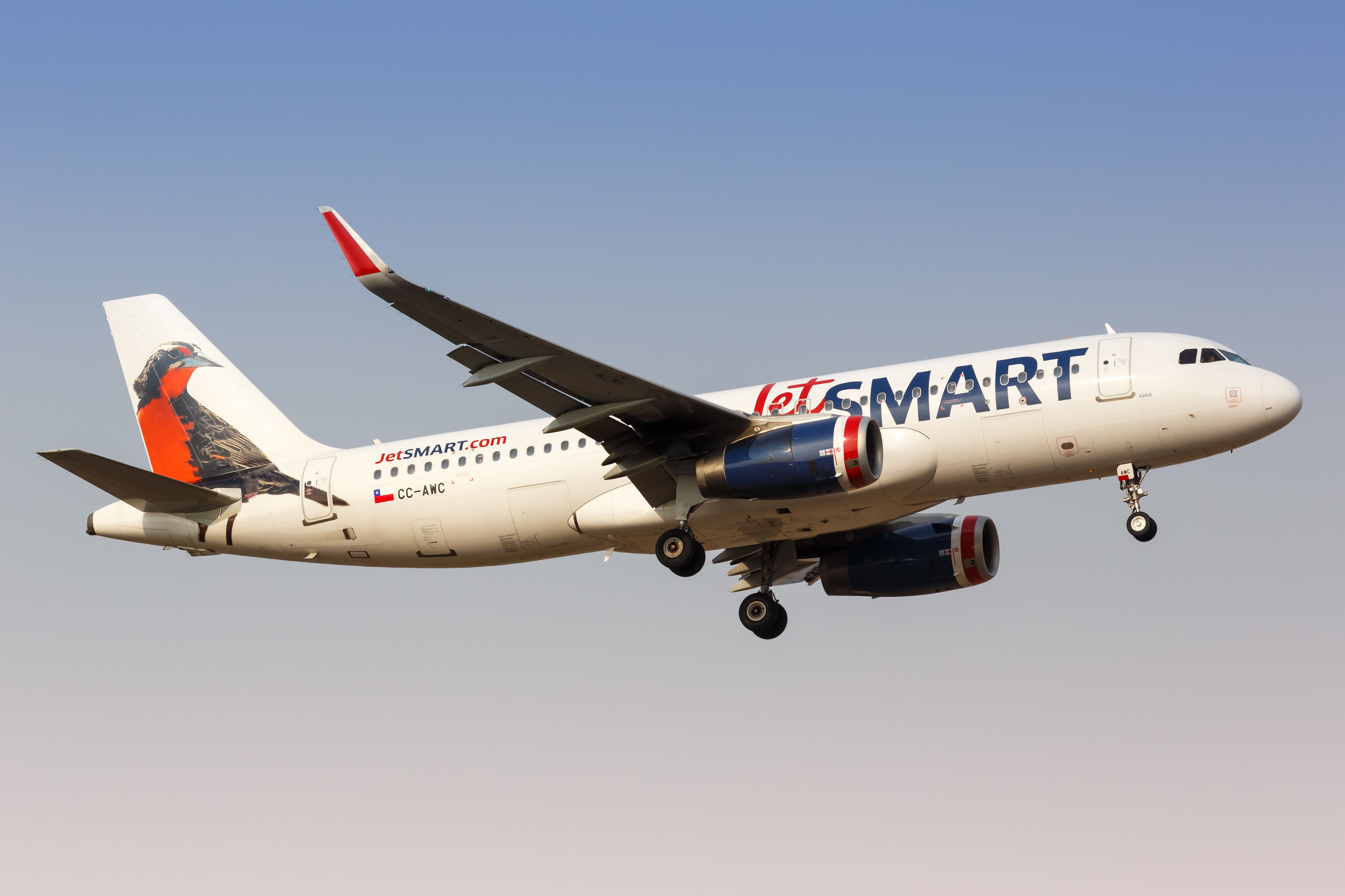 A JetSMART Airbus A320 flying in the sky.
