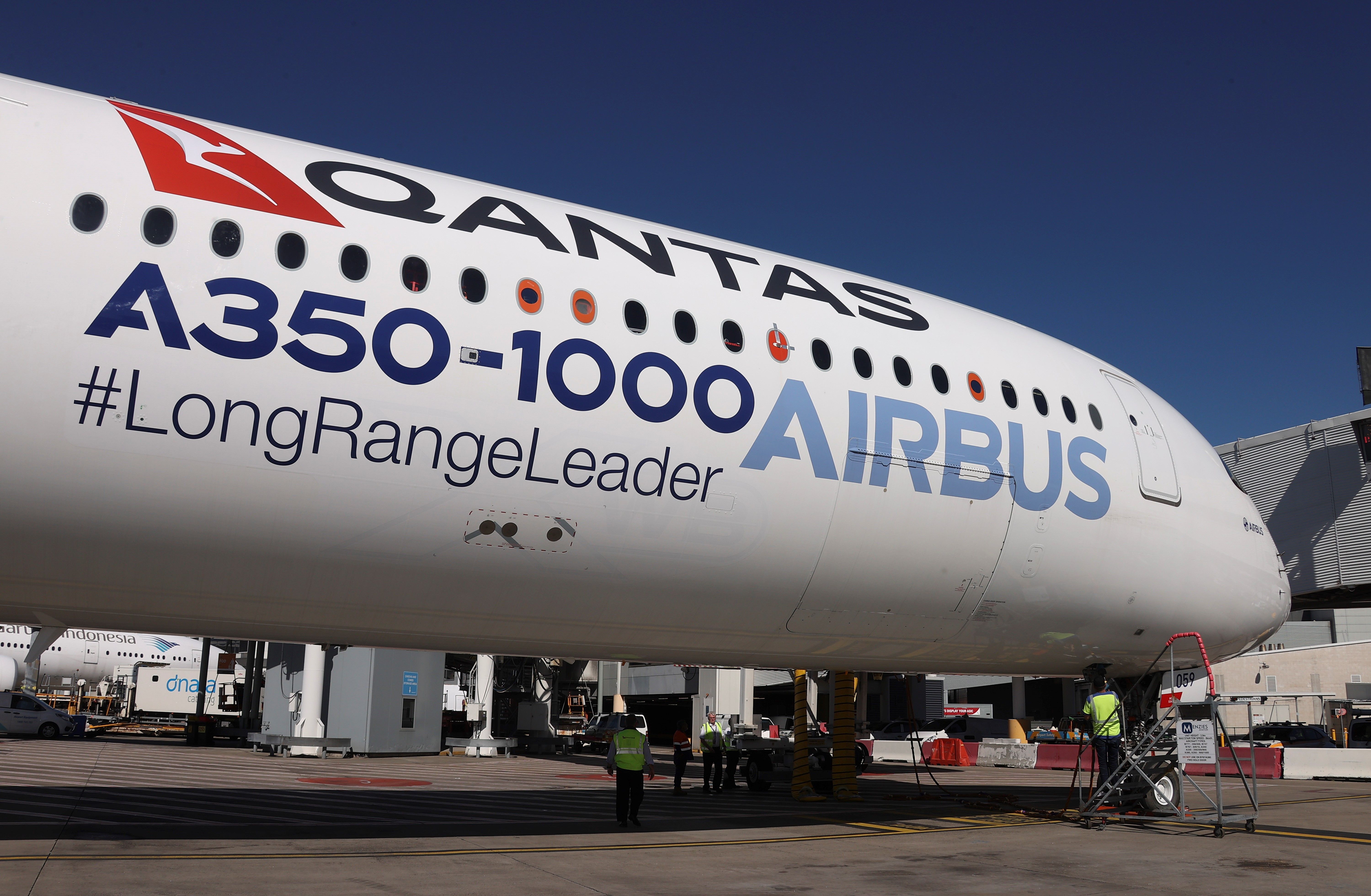 A Qantas Airbus A350-1000 parked on an airport apron.