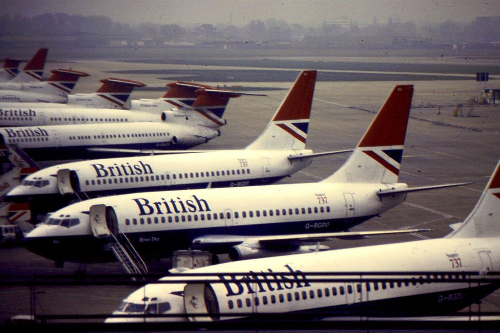 Multiple British Airways Boeing 737s and Trident aircraft lined up at Heathrow Airport.