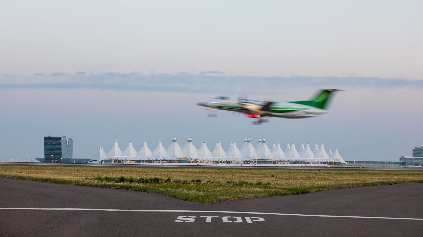 Turboprop taking off in front of Denver International Airport