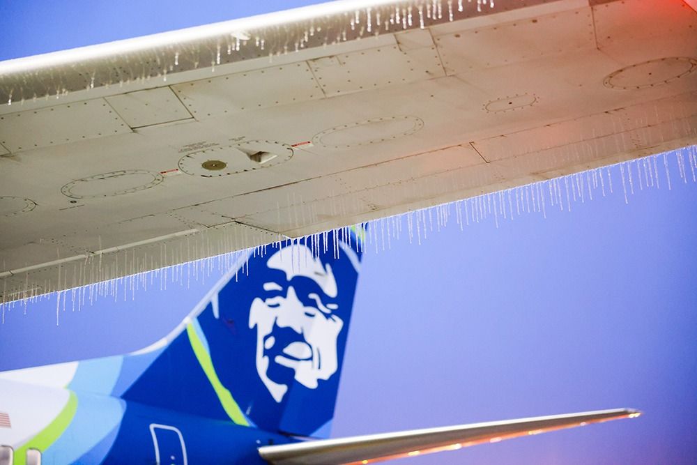 Ice hangs off the wing of an airplane at Sea-Tac International Airport. 