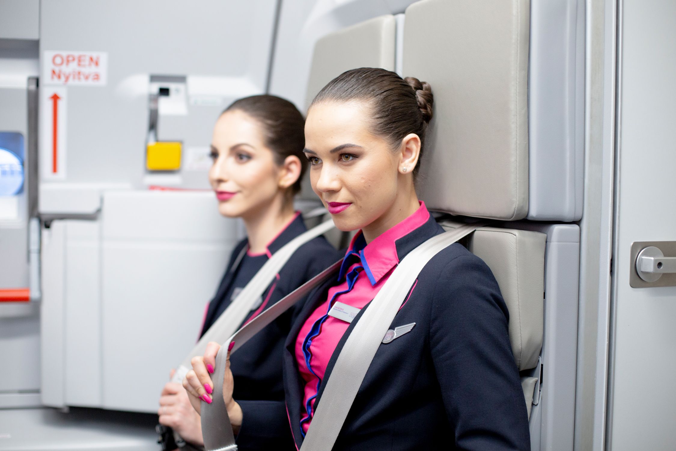 Wizz Air cabin crew on jump seats.