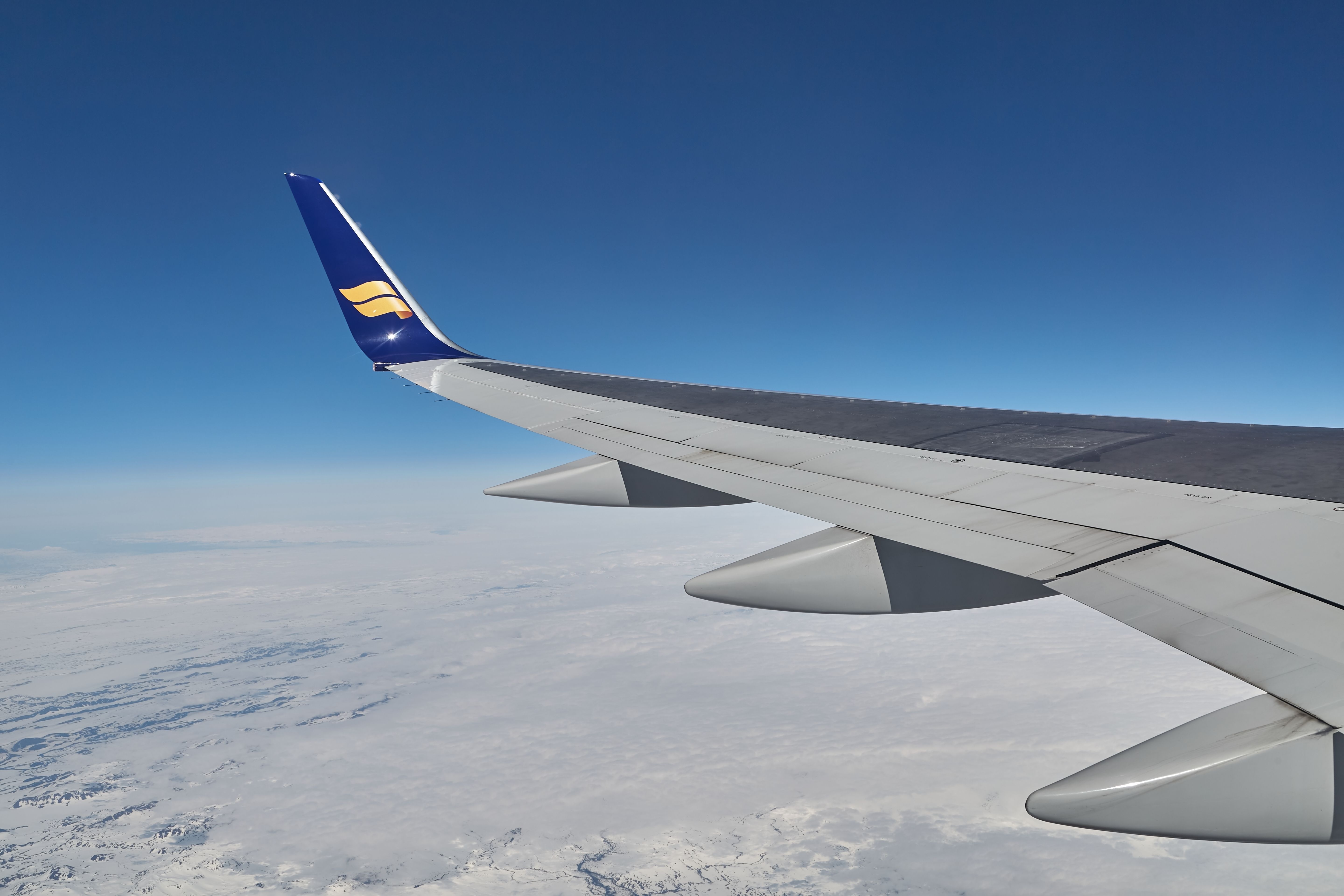 Reykjavik, Iceland - Circa 2018 Icelandair flight wingtip seen over cloud cover on a flight, looking out the window 