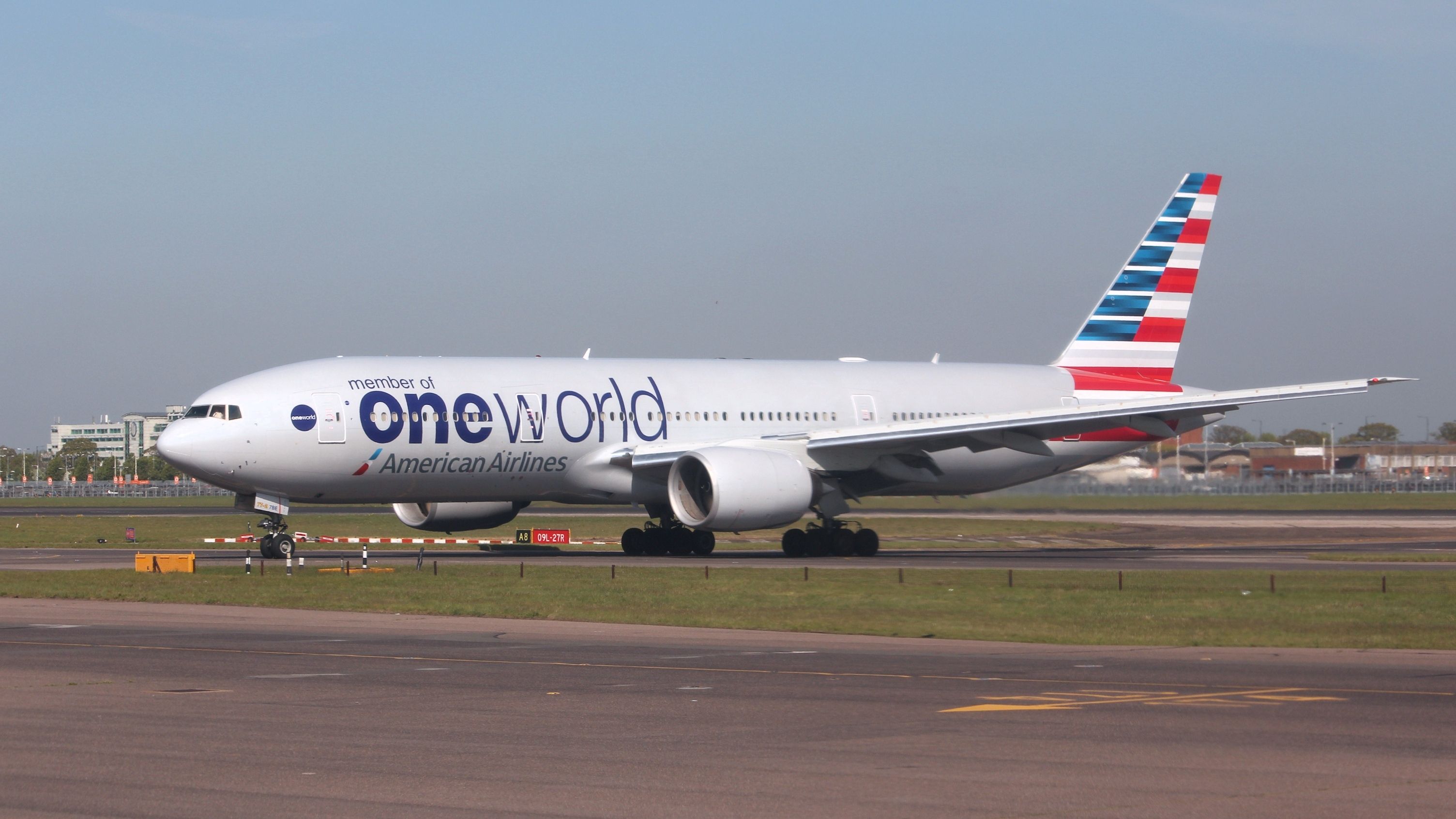 An American Airlines aircraft in oneworld livery taxiing to the airport gate.