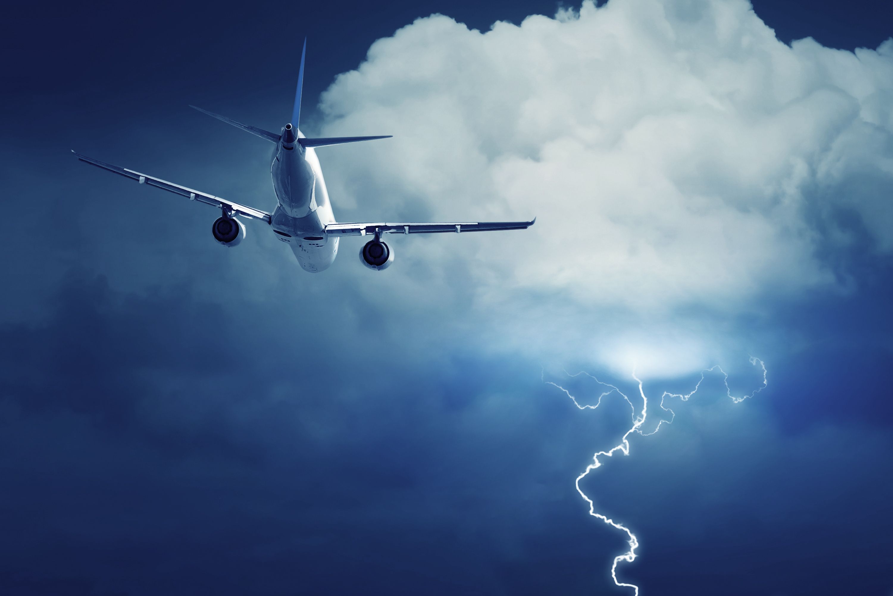 An airplane flying into a thunderstorm.
