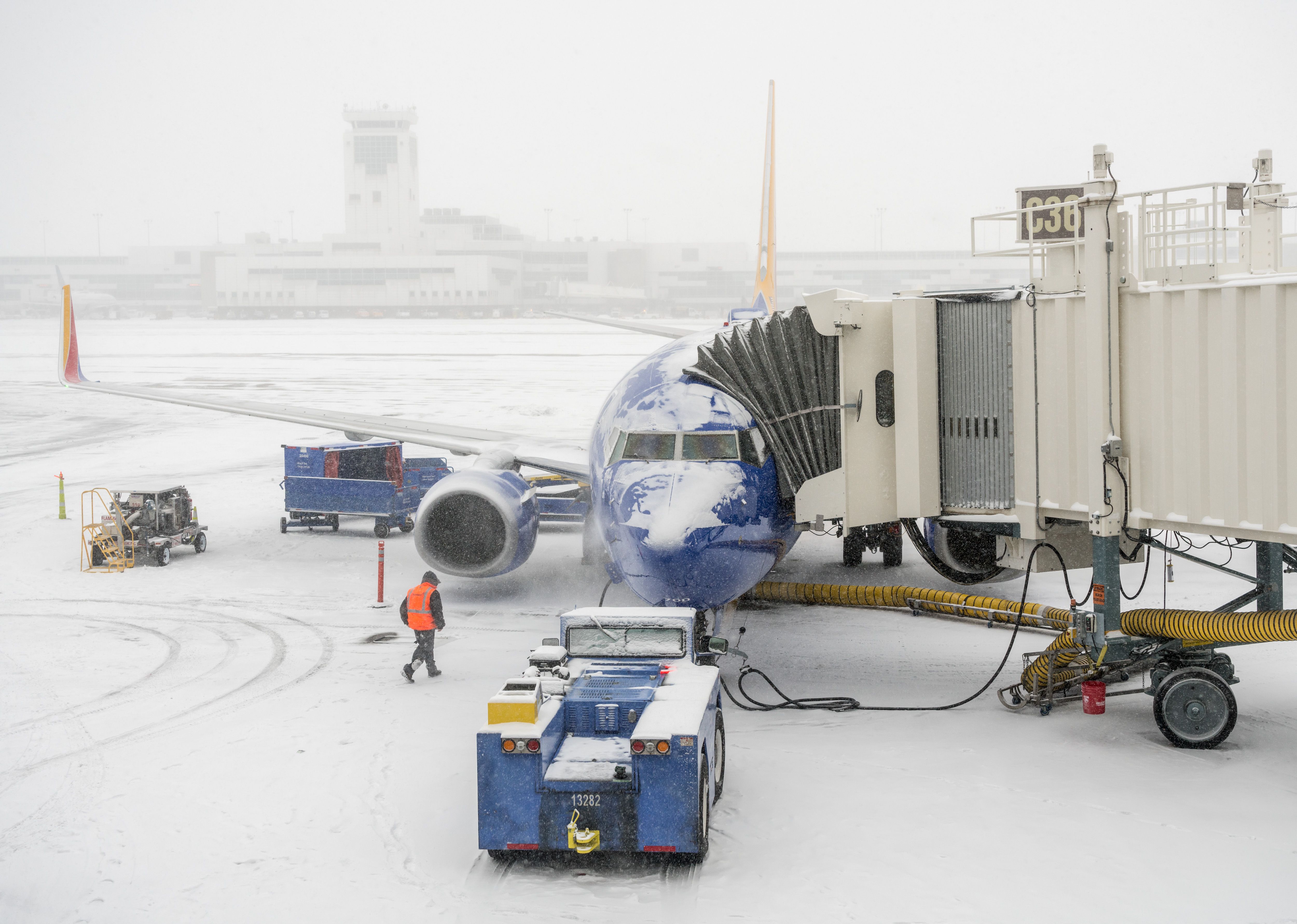 shutterstock_1305194401 - DENVER, COLORADO: JANUARY 24, 2019: Southwest planes being loaded at the jetway in snow storm
