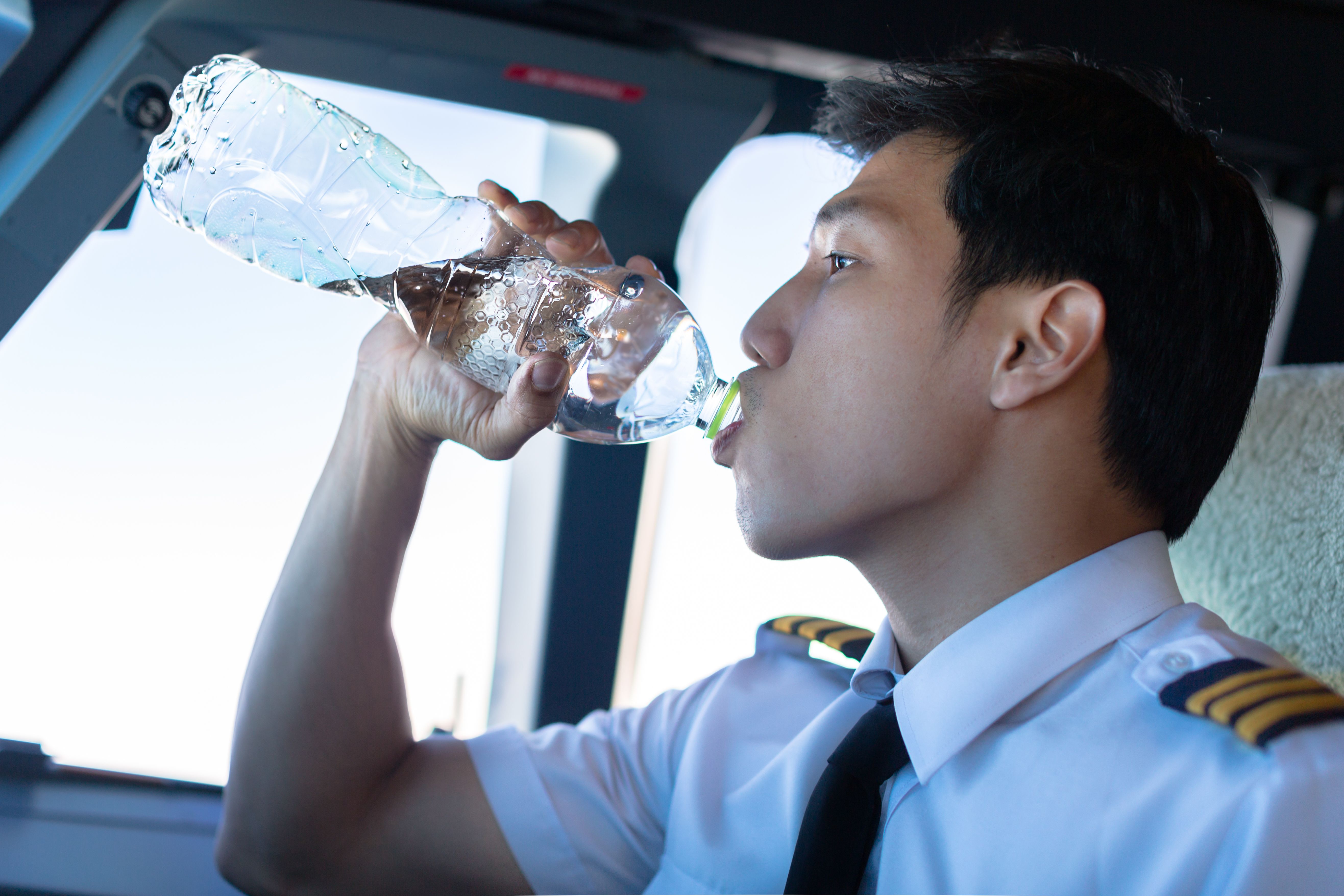 A pilot drinking water