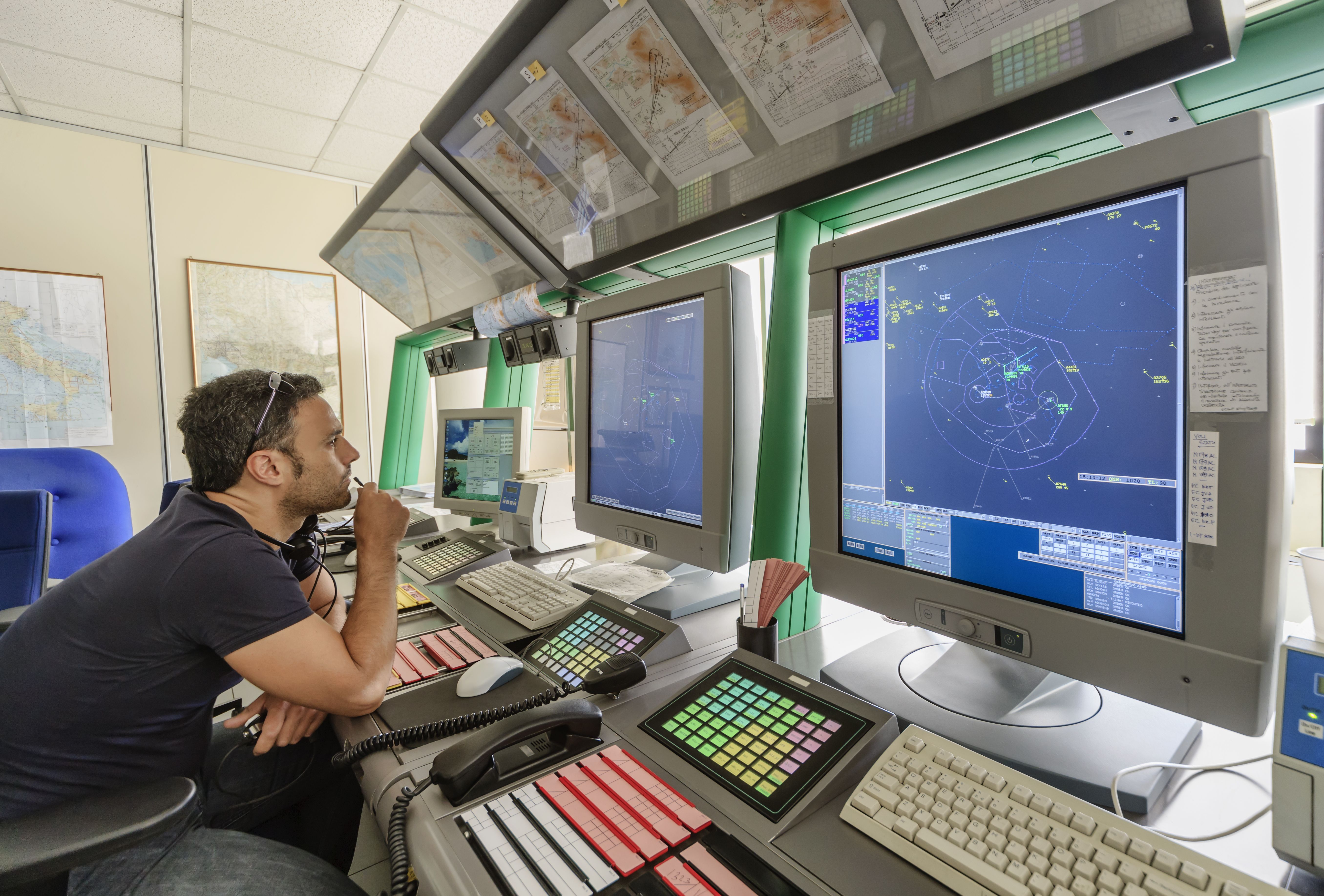 An air traffic controller at work in front of a screen.