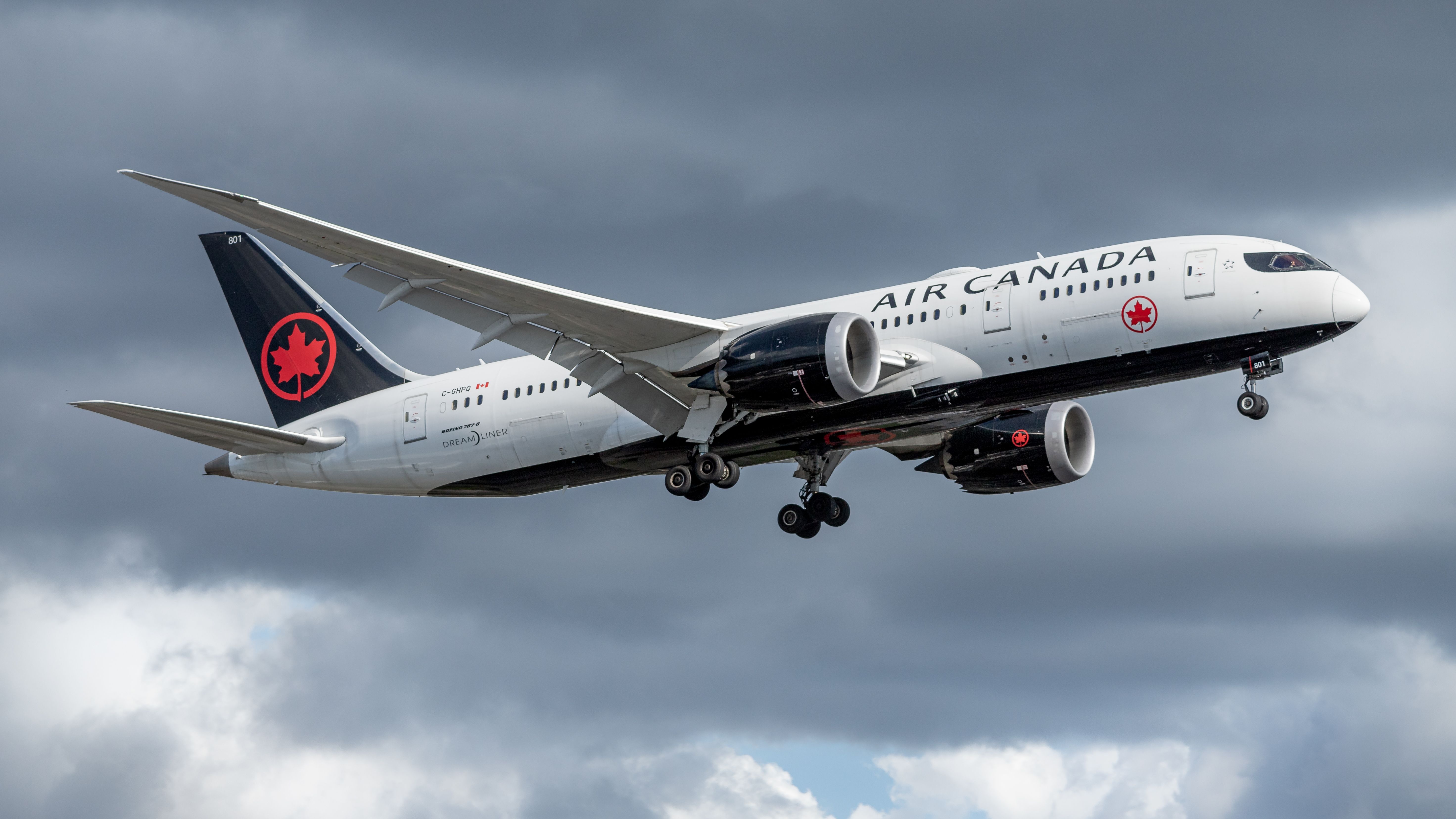 An Air Canada Boeing 787 flying in the sky.