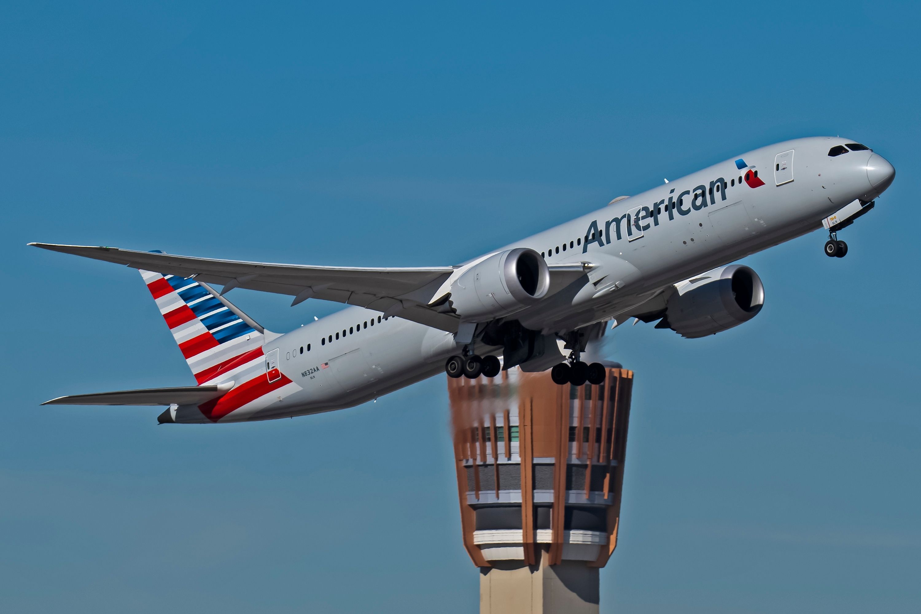 An American Airlines Boeing 787-9 with Phoenix tower in the background.