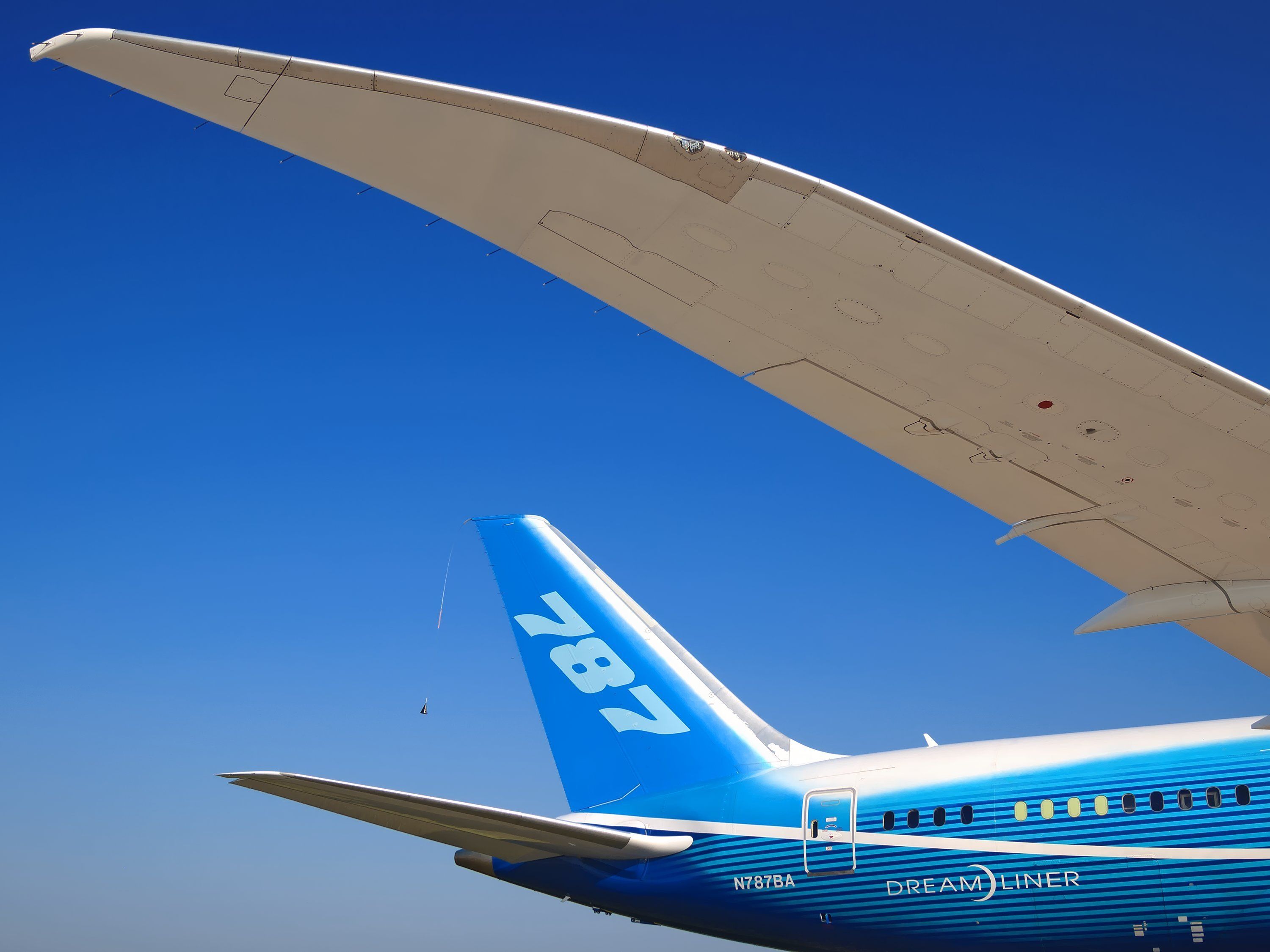 MOSCOW REGION, RUSSIA - AUGUST, 2011: Boeing Company Boeing 787 Dreamliner passenger jet airplane in dreamliner color scheme with winglets close up, 787 markings on fin wide panoramic detail view