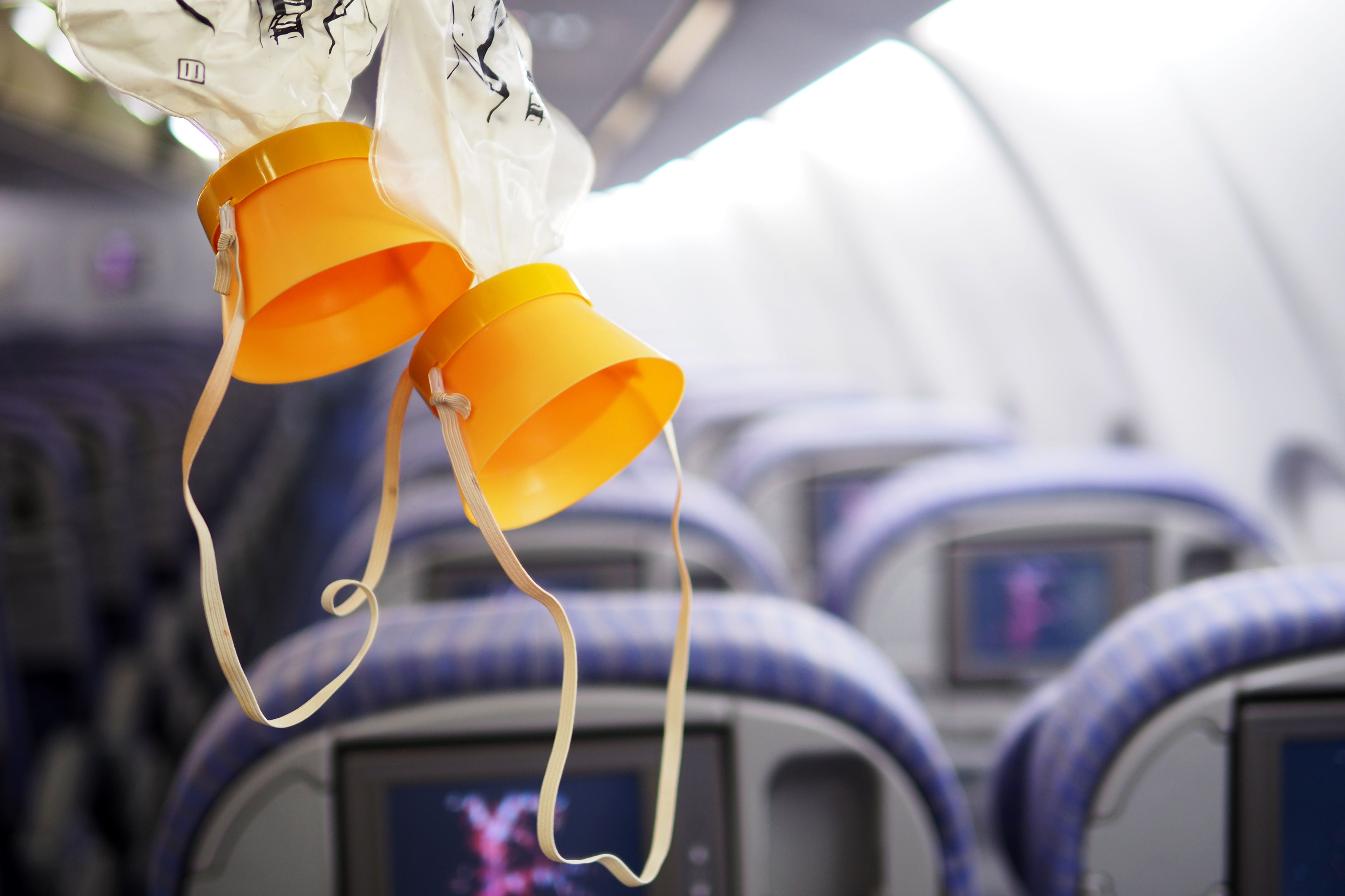 Oxygen Masks deployed inside a passenger aircraft cabin.