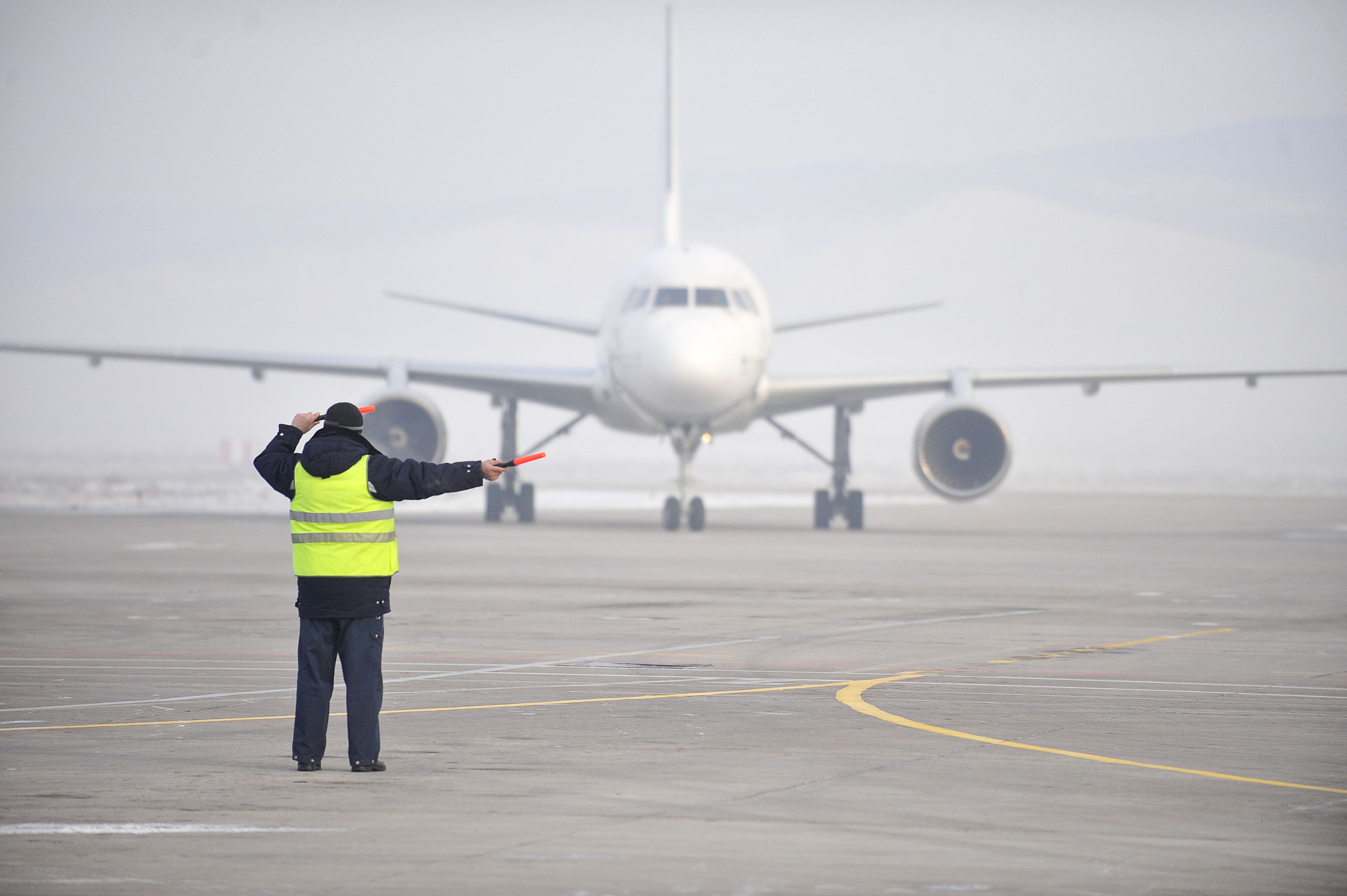 PLane at an airport in the fog