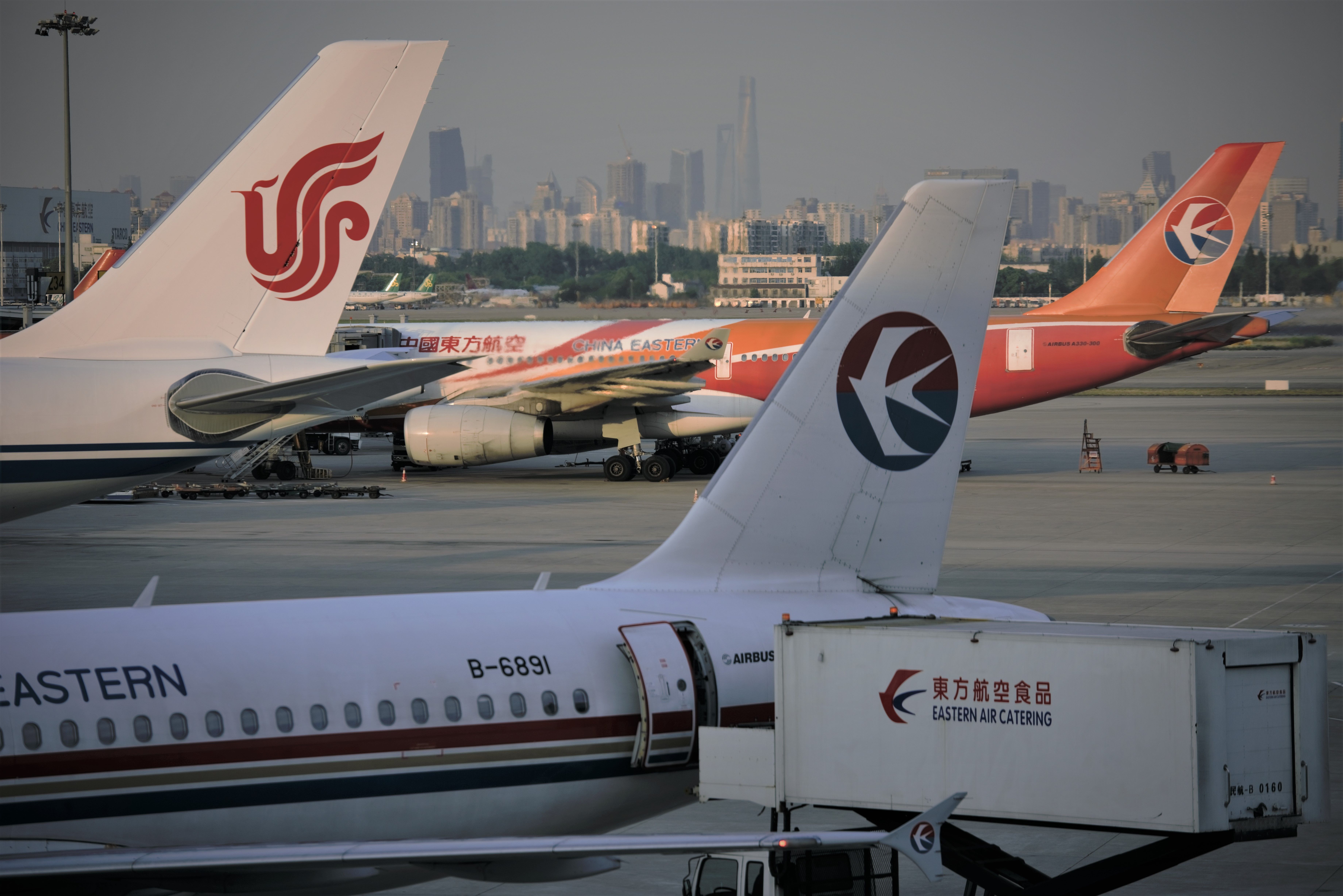 Air China and China Eastern aircraft tails at Shanghai Pudong Airport.