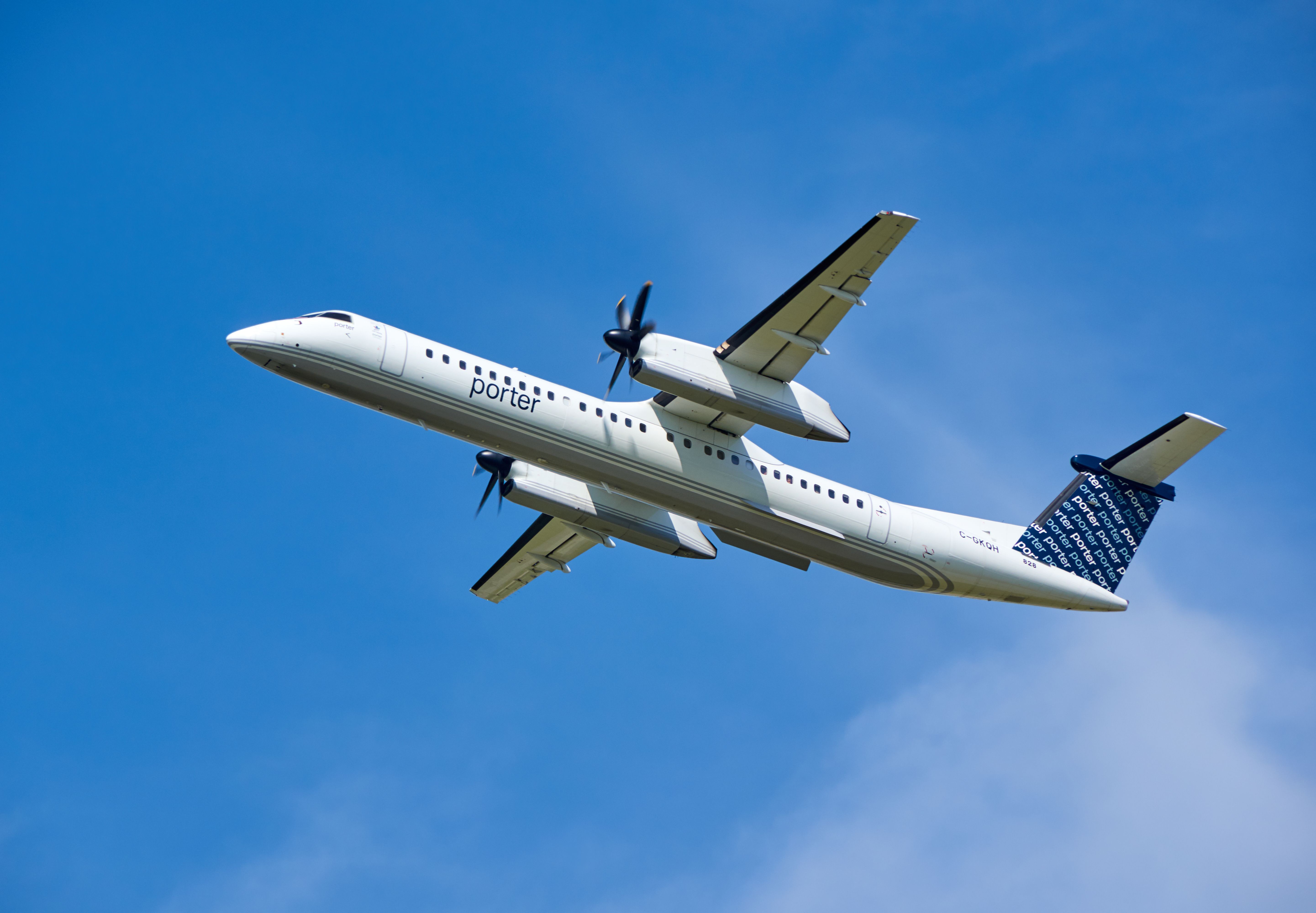 A Porter Airlines Dash 8-Q400 flying below the clouds.