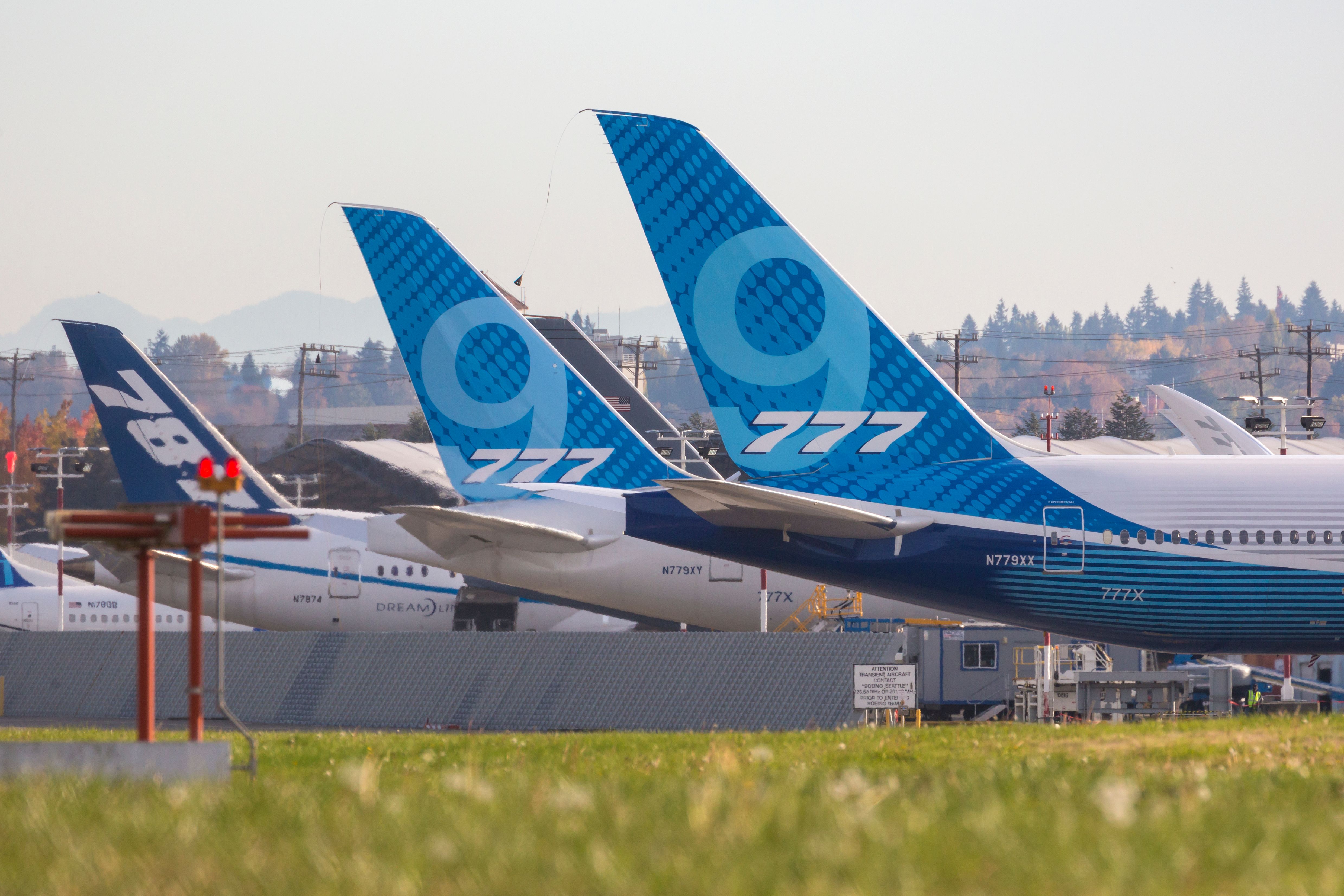 Various Boeing aircraft lined up on a ramp for service at King County International Airport 