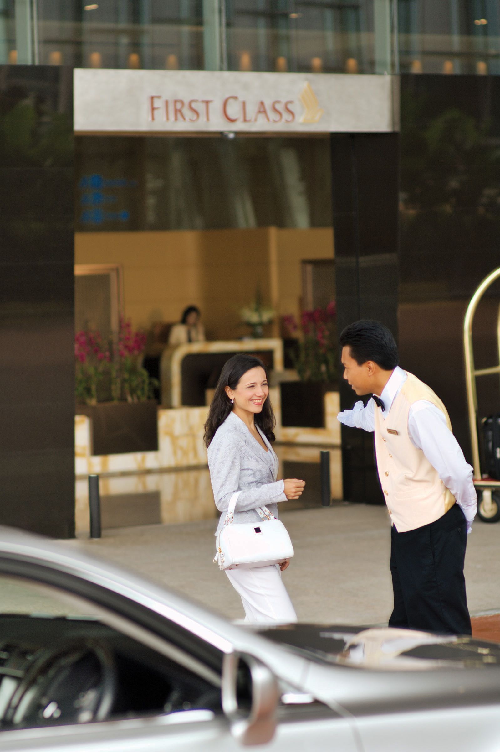 A passenger entering the Singapore Airlines first class check-in area.