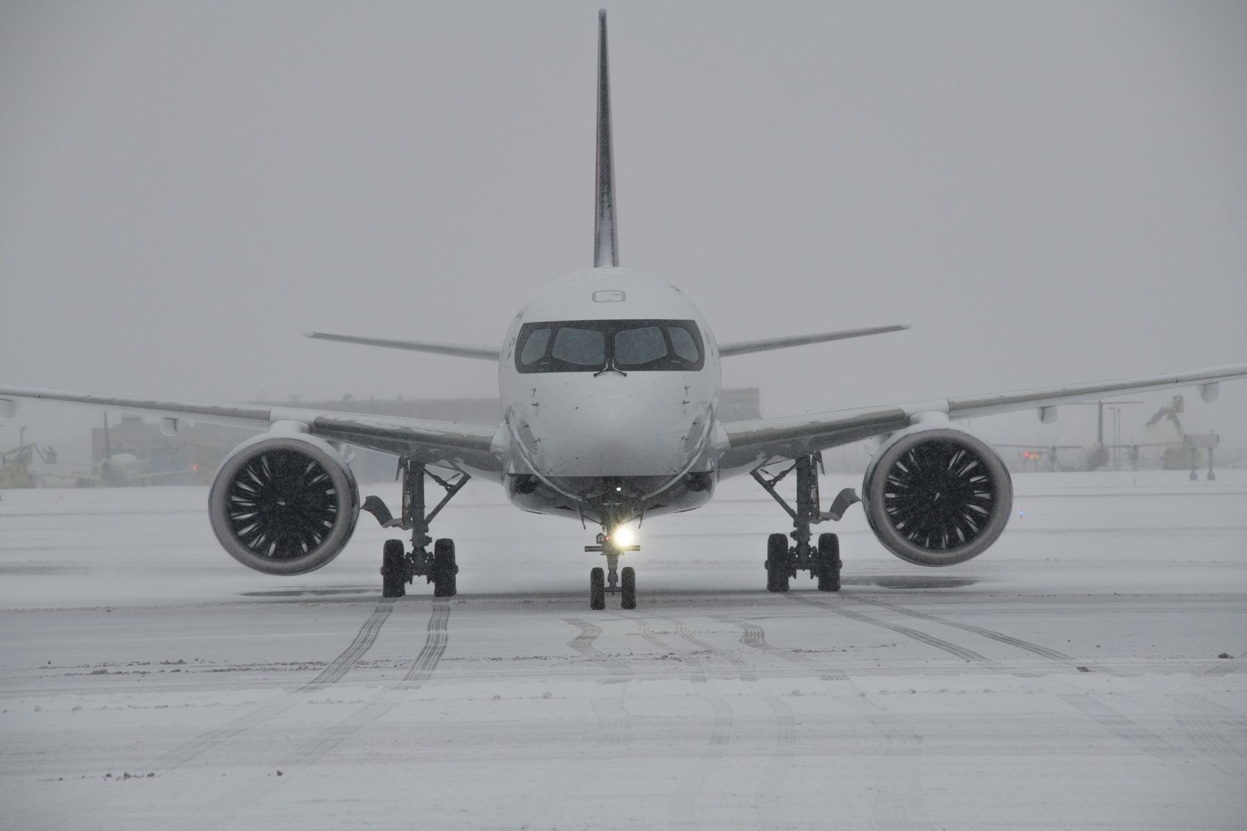 An Air Canada Airbus A220-300 in a snowy environment