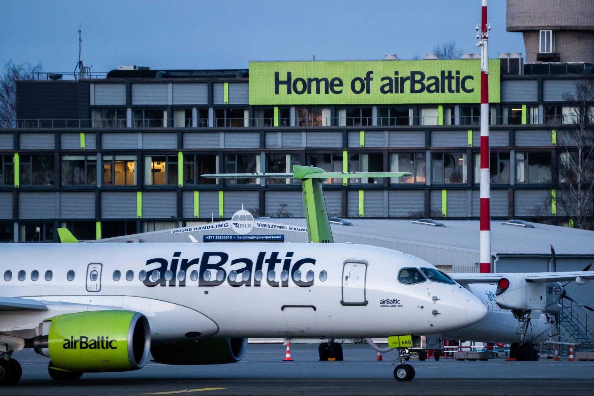 An airBaltic Airbus A220 parked at RIX airport