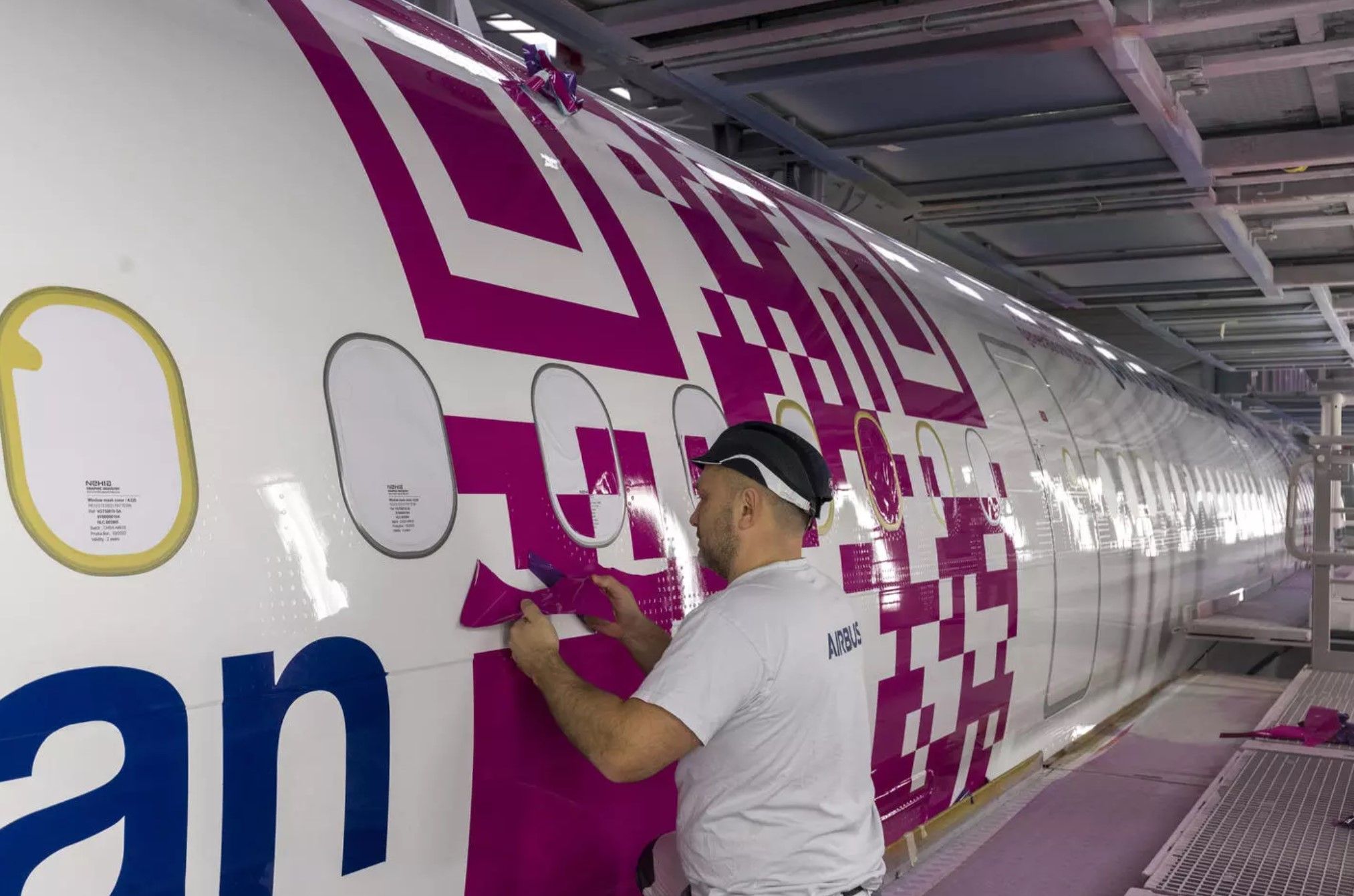 A worker paints the Airbus A321XLR's QR Code.