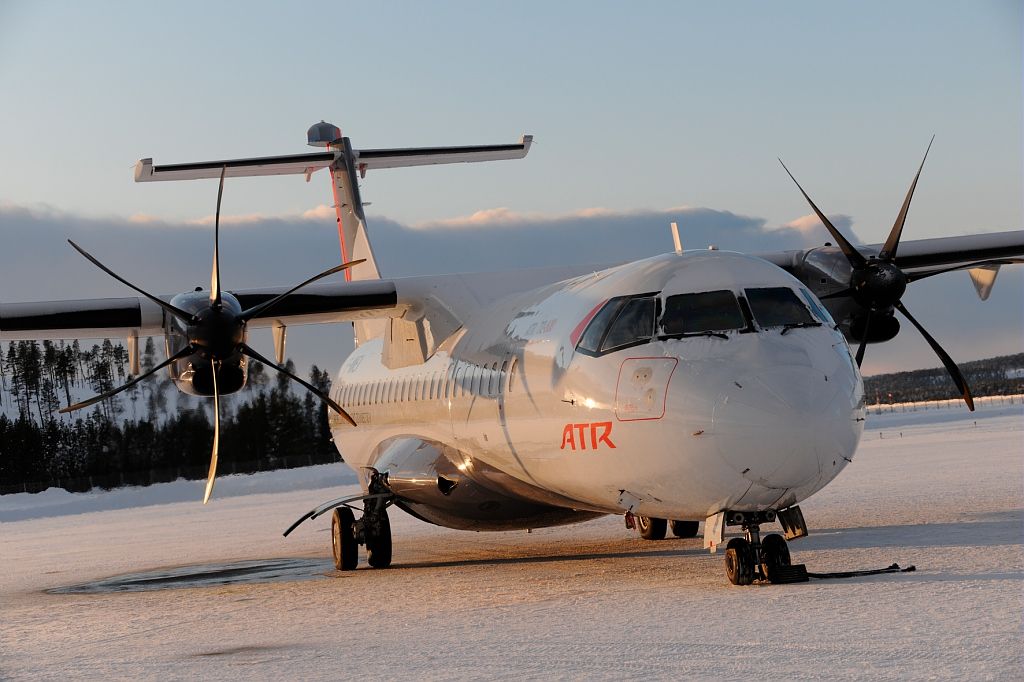 An ATR 72 parked in a snowy runway