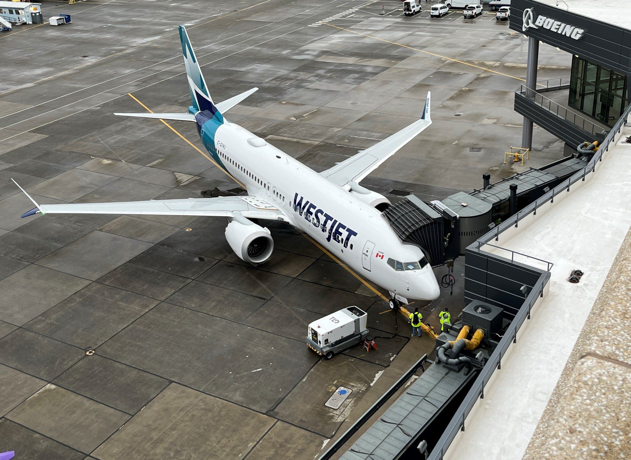 A WestJet Boeing 737 MAX 8 parked at an airport.