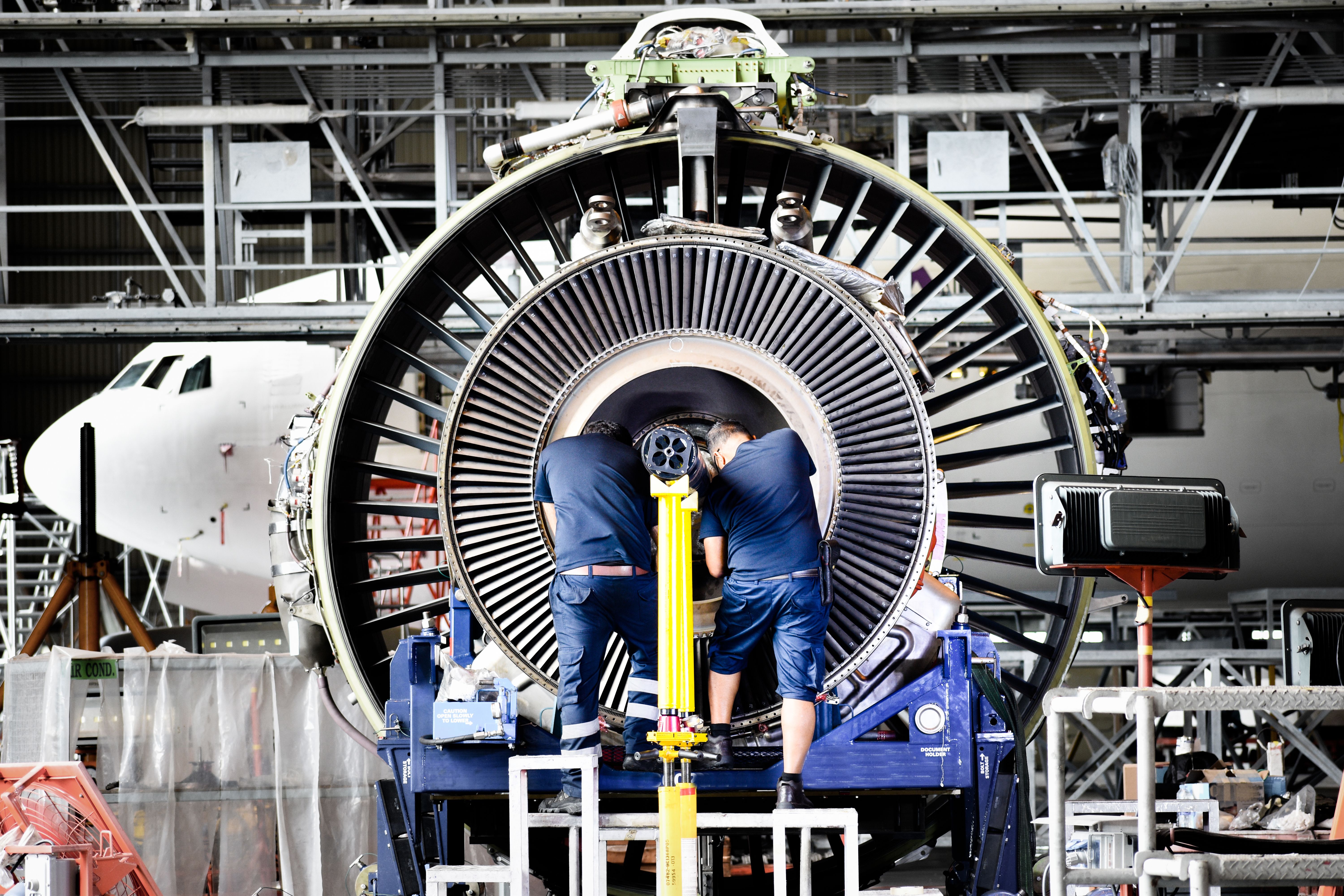 A jet engine removed from an aircraft for maintenance in the hangar.