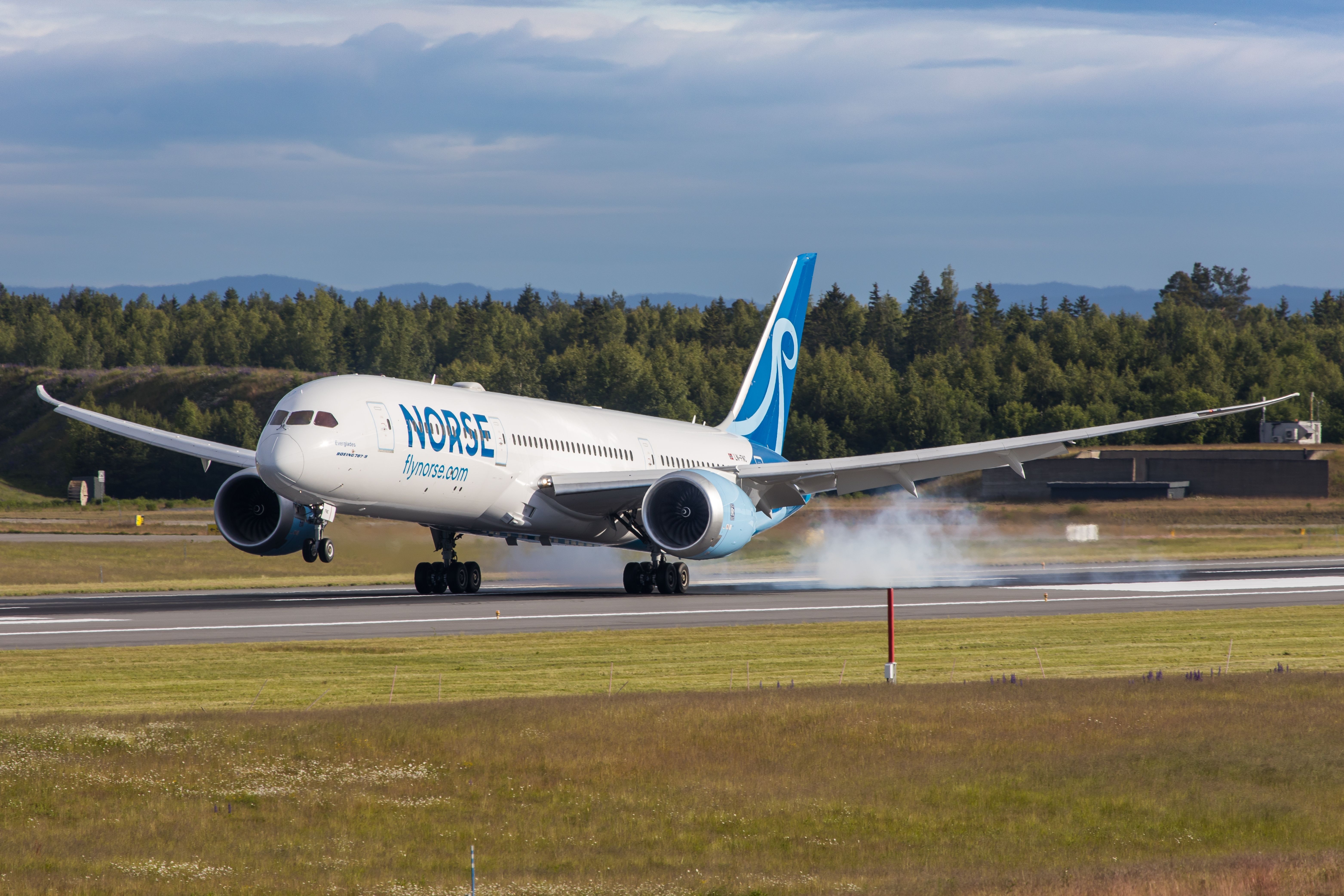 A Norse Atlantic Airways Boeing 787 just after touch down on a runway.