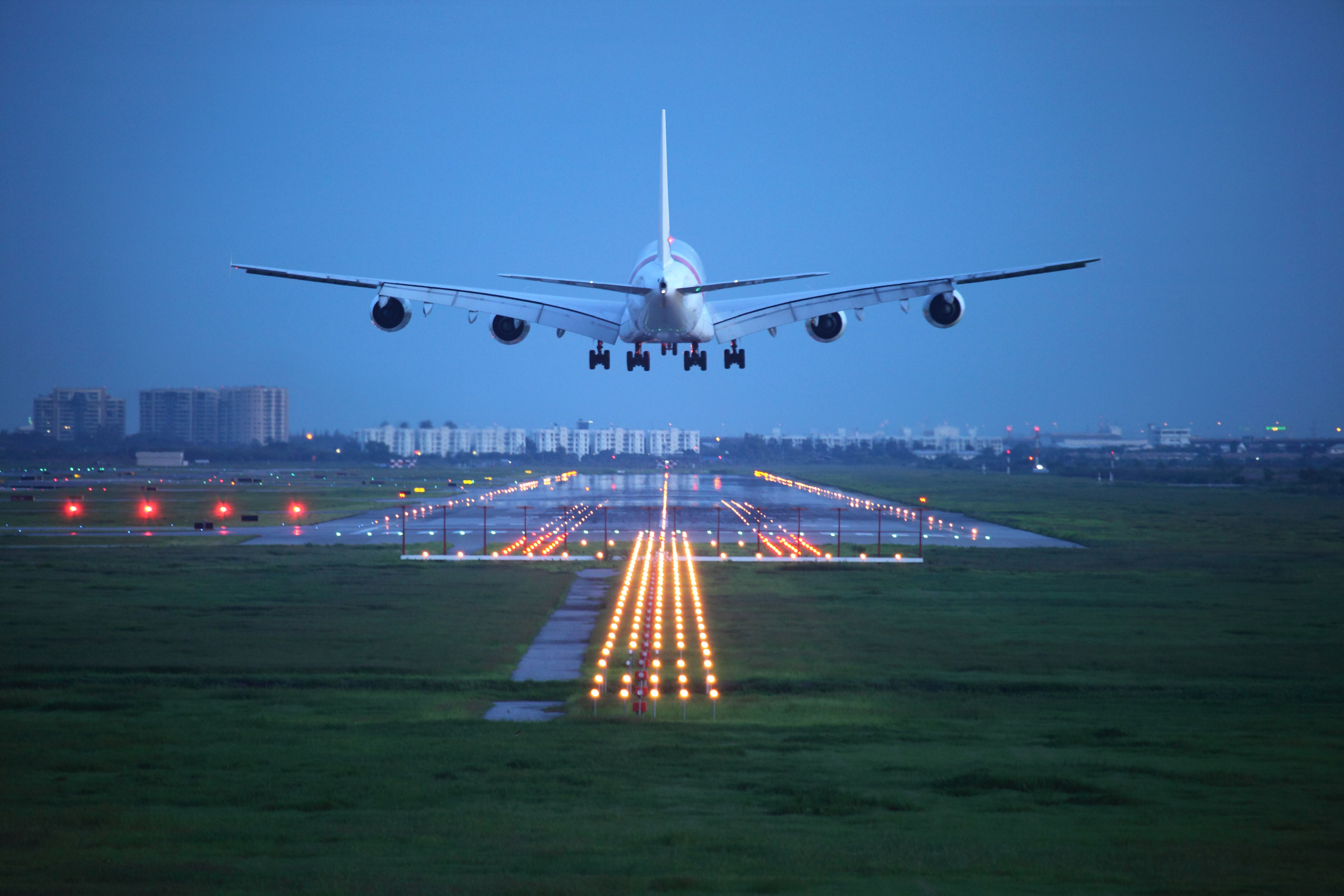 Quadjet landing on runway at dusk