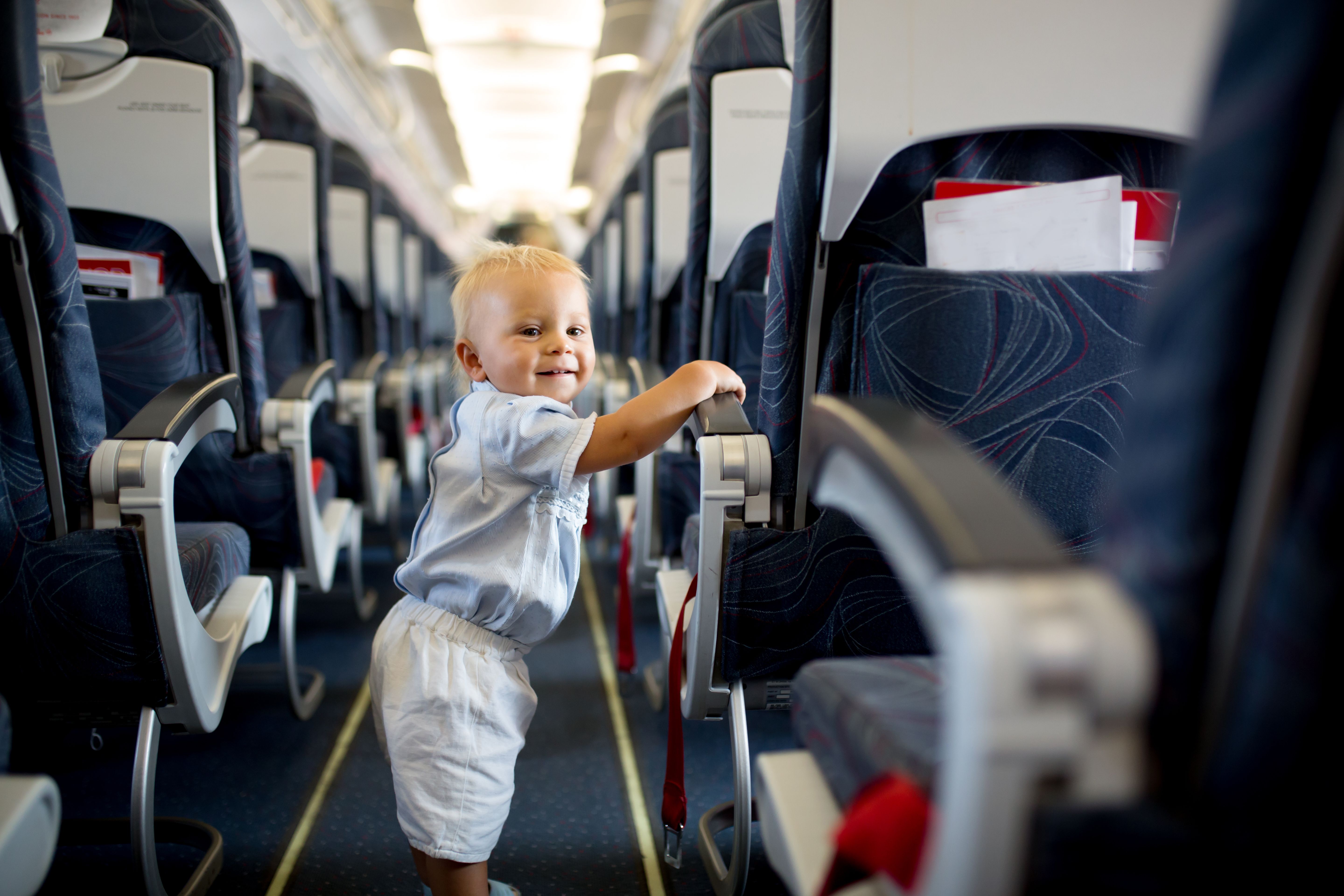 Child in airplane aisle