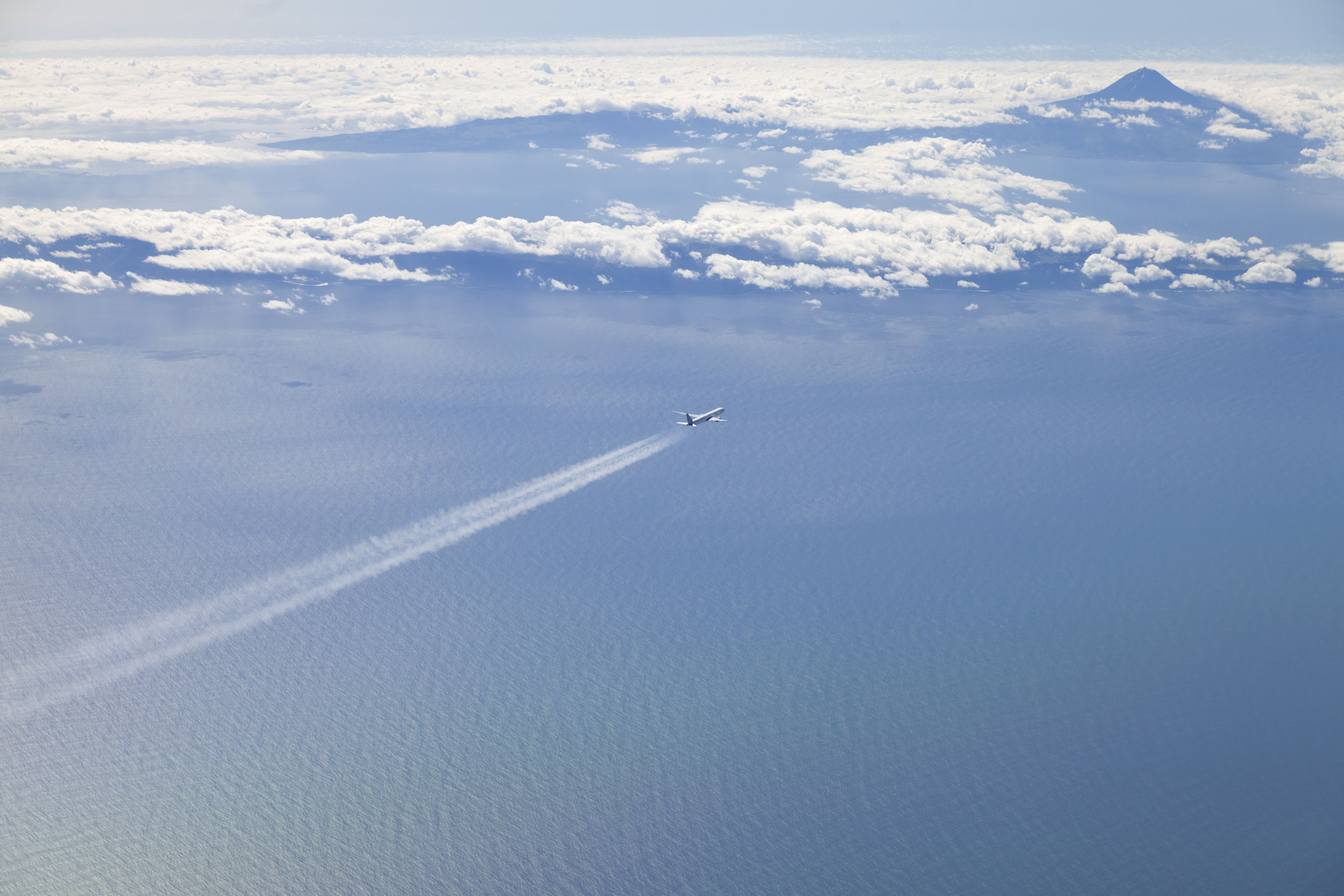 A plane in cruise over open water. 