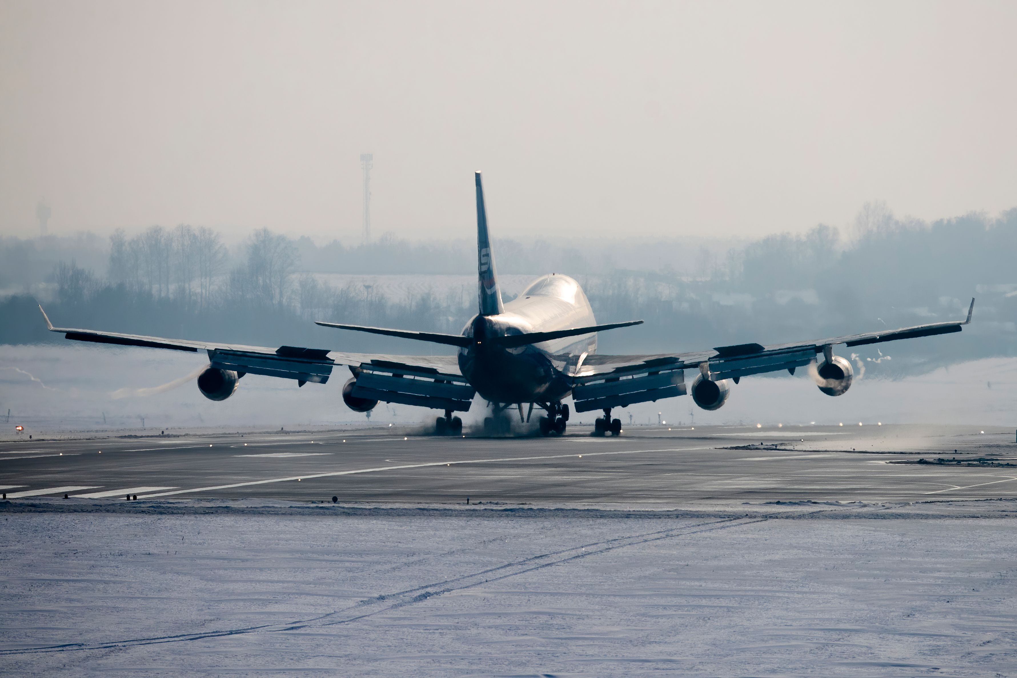 A Boeing 747 Landing on a snowy runway.