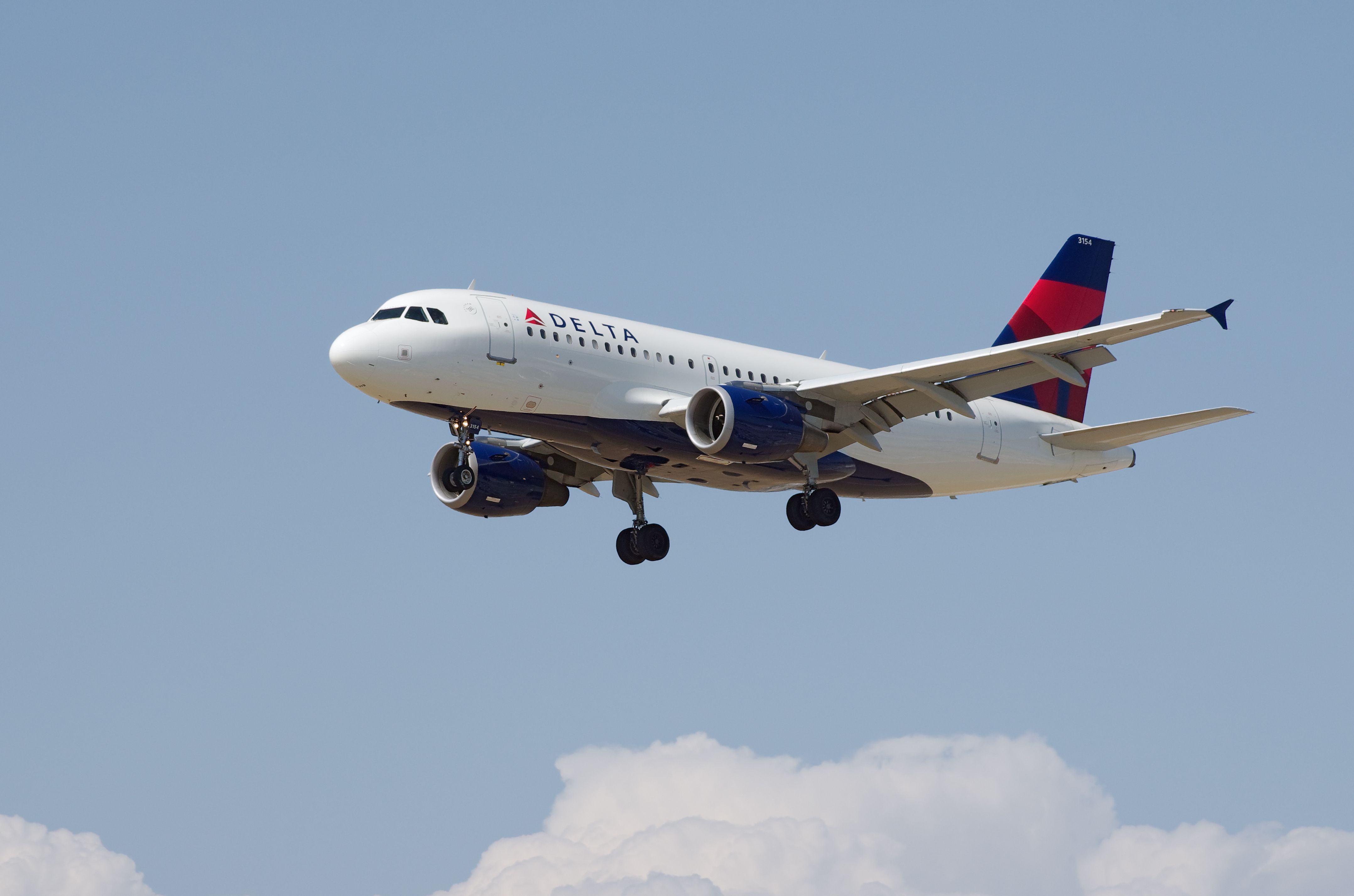 A Delta Airbus A319 flying in the sky.