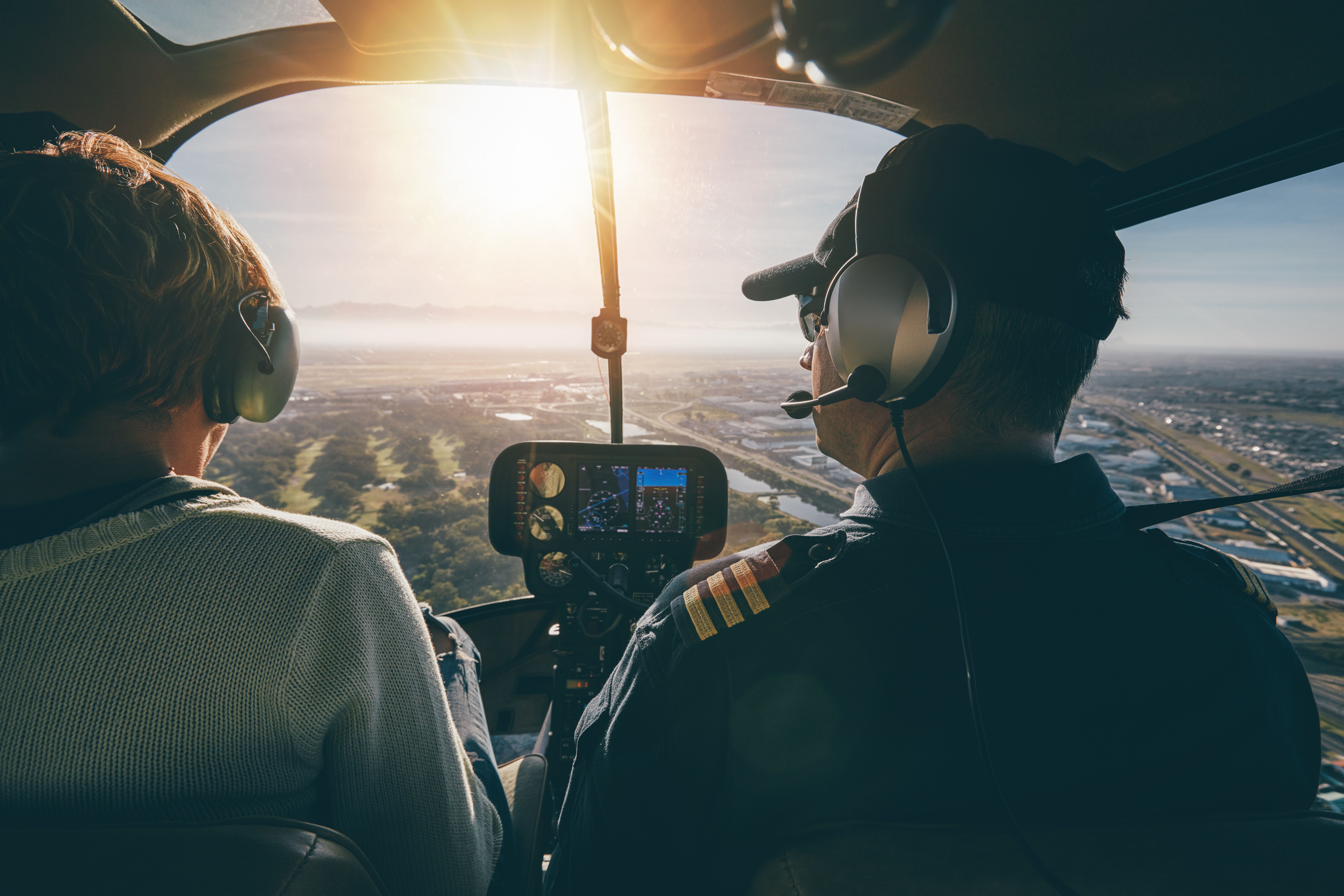 An instructor and student facing the sun in the flight.