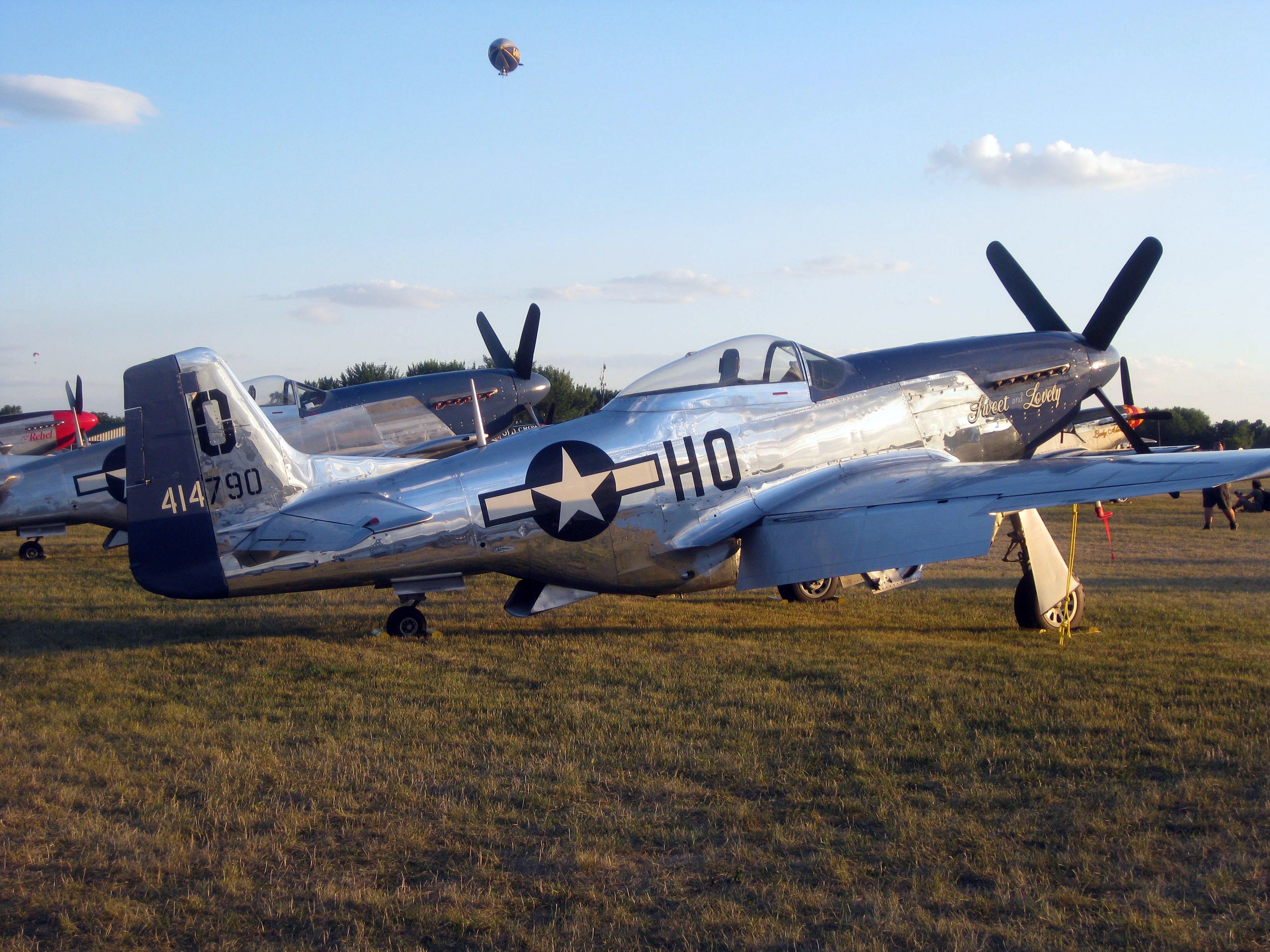 A P-51 Mustang parked in a field.