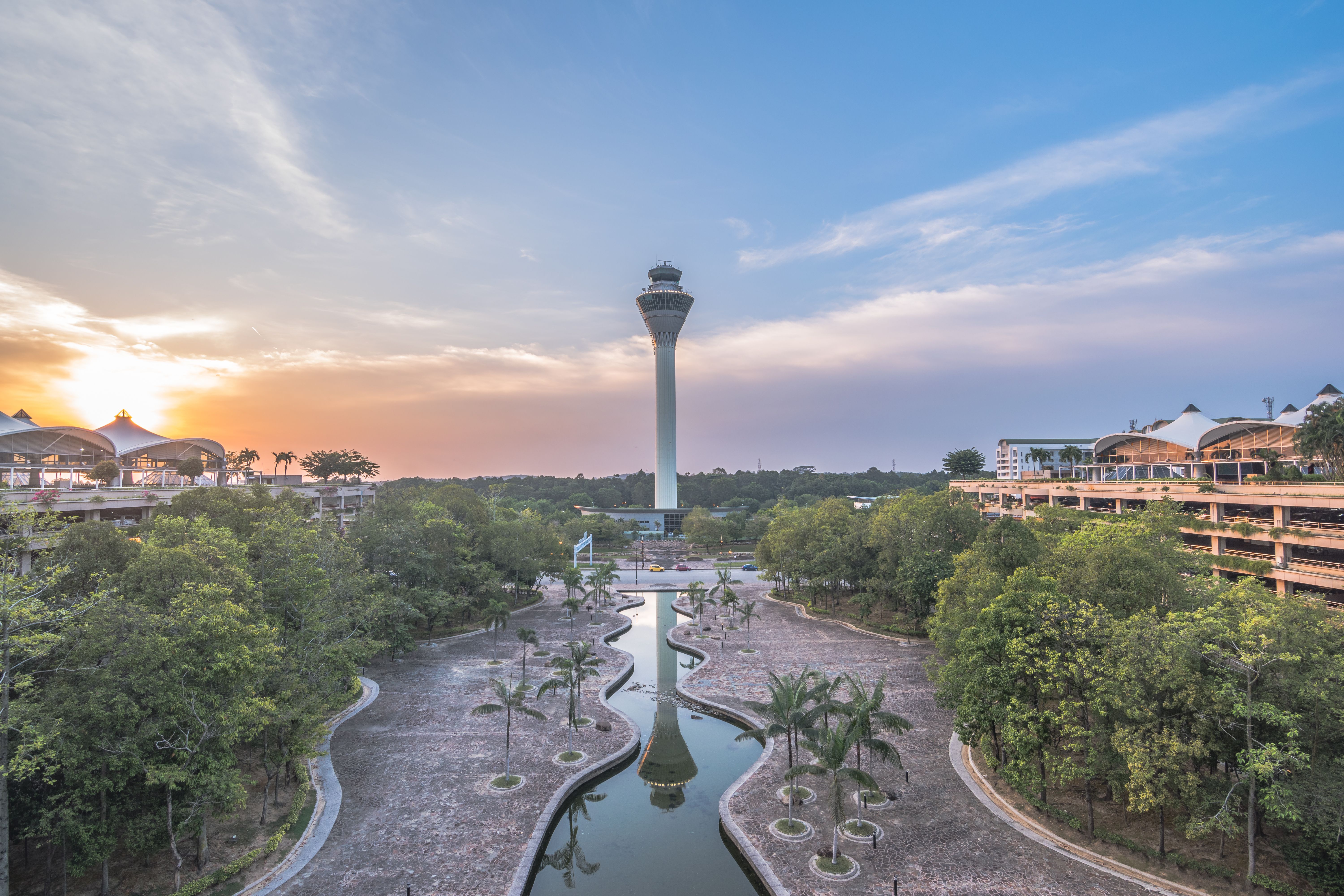 Kuala Lumpur airport control tower with park at sunsest