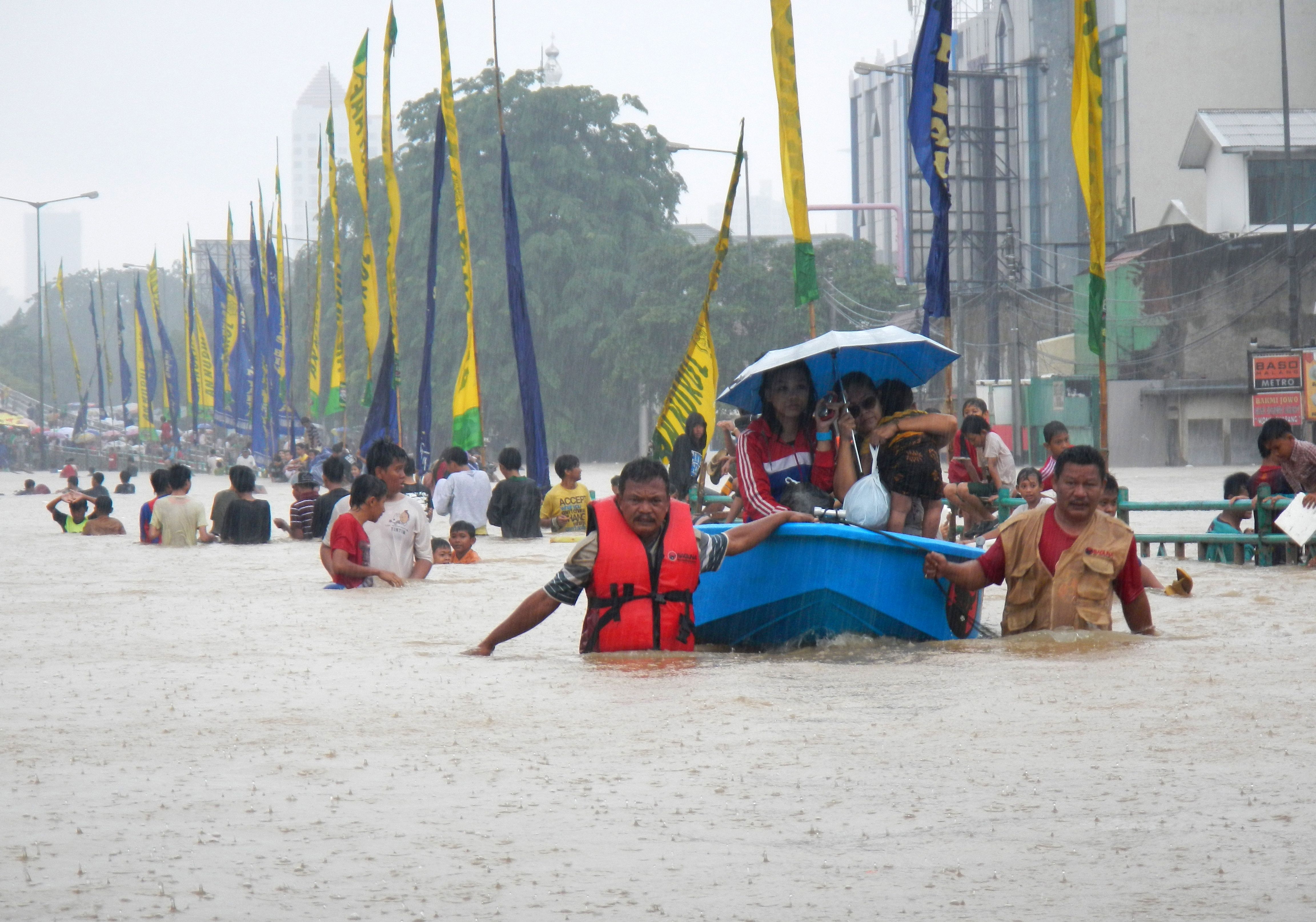 Jakarta flooded with people in rubber boats