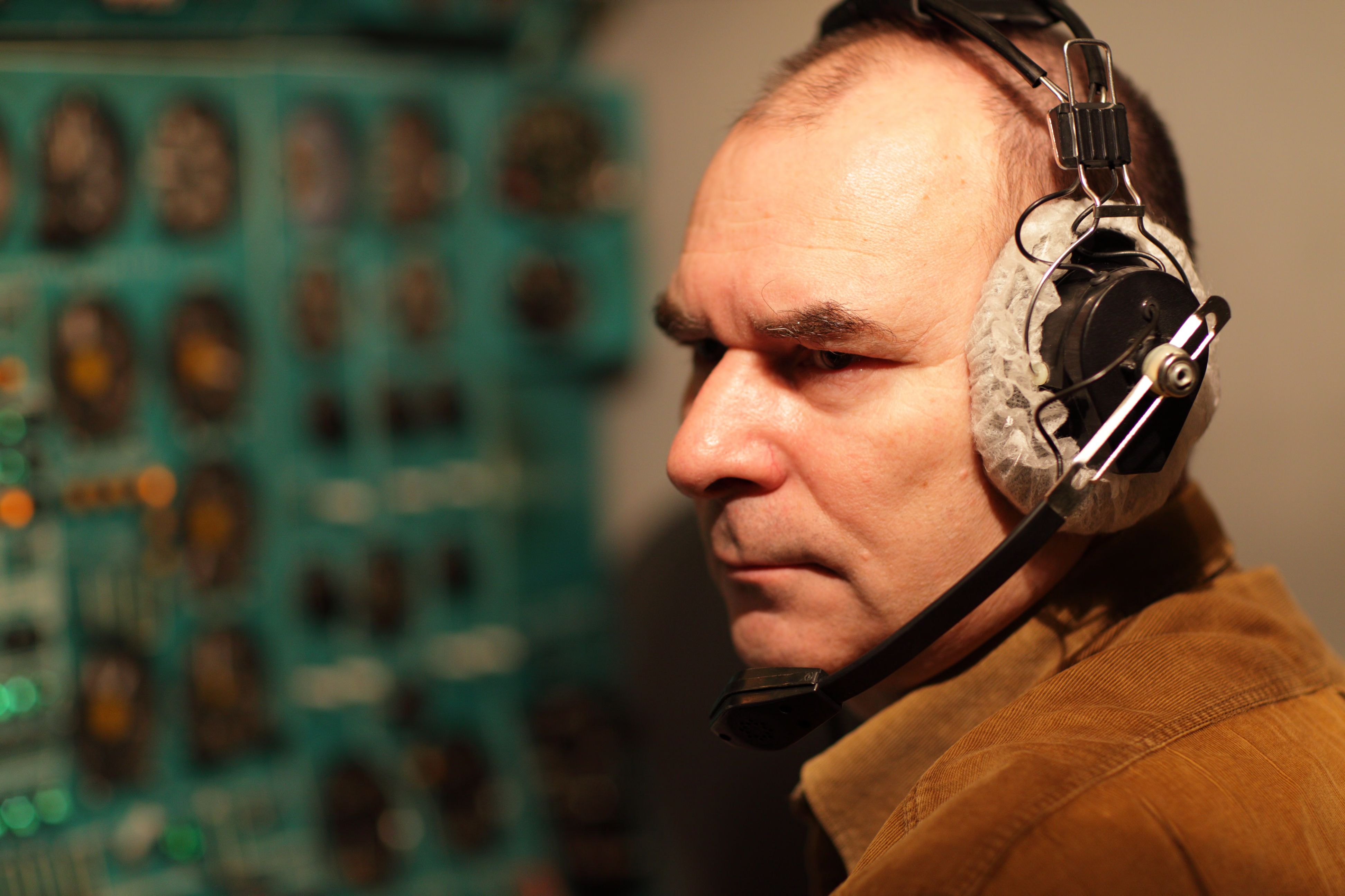 A flight engineer wearing an older noise reduction headset.