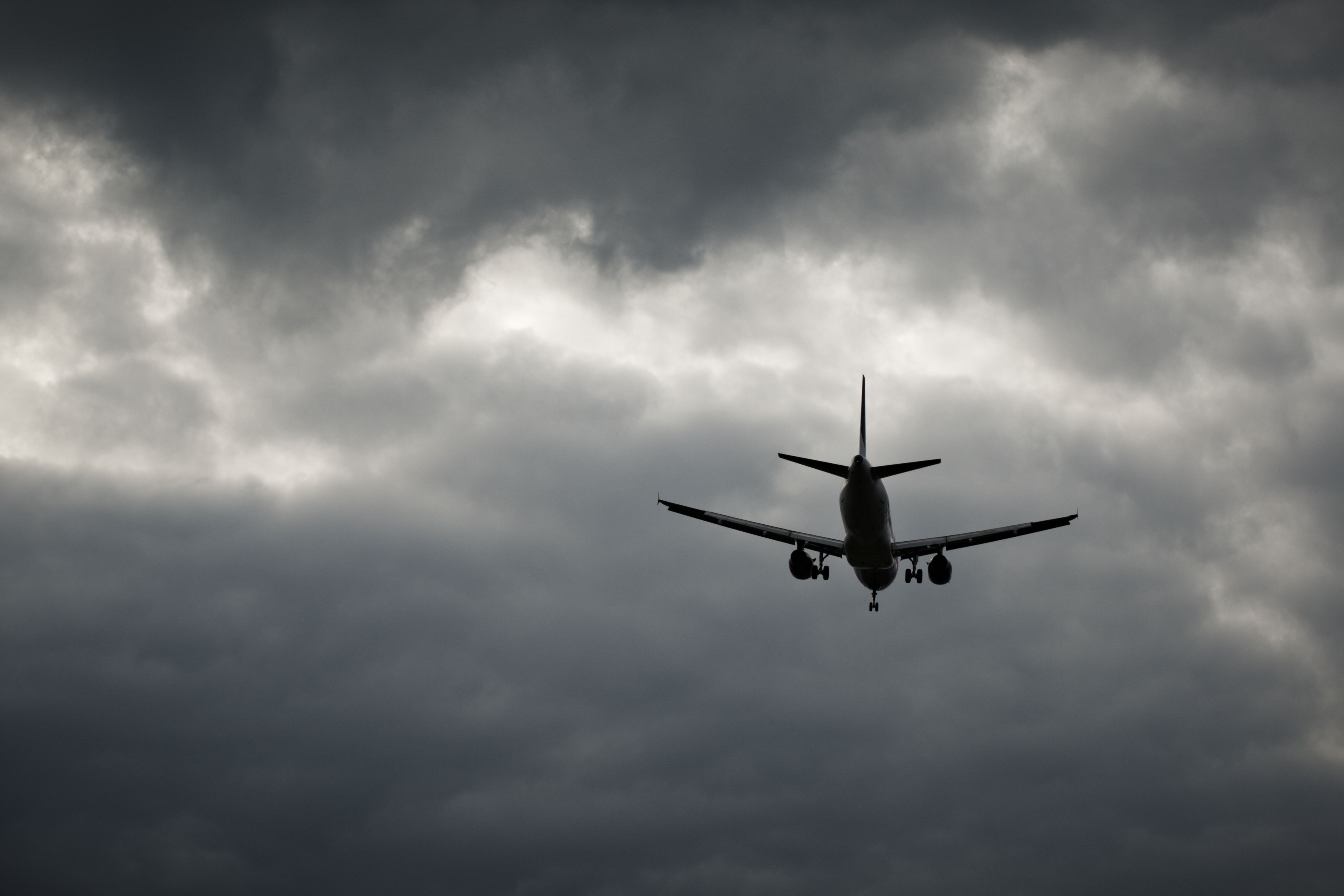 Plane In Storm Clouds Silhouette