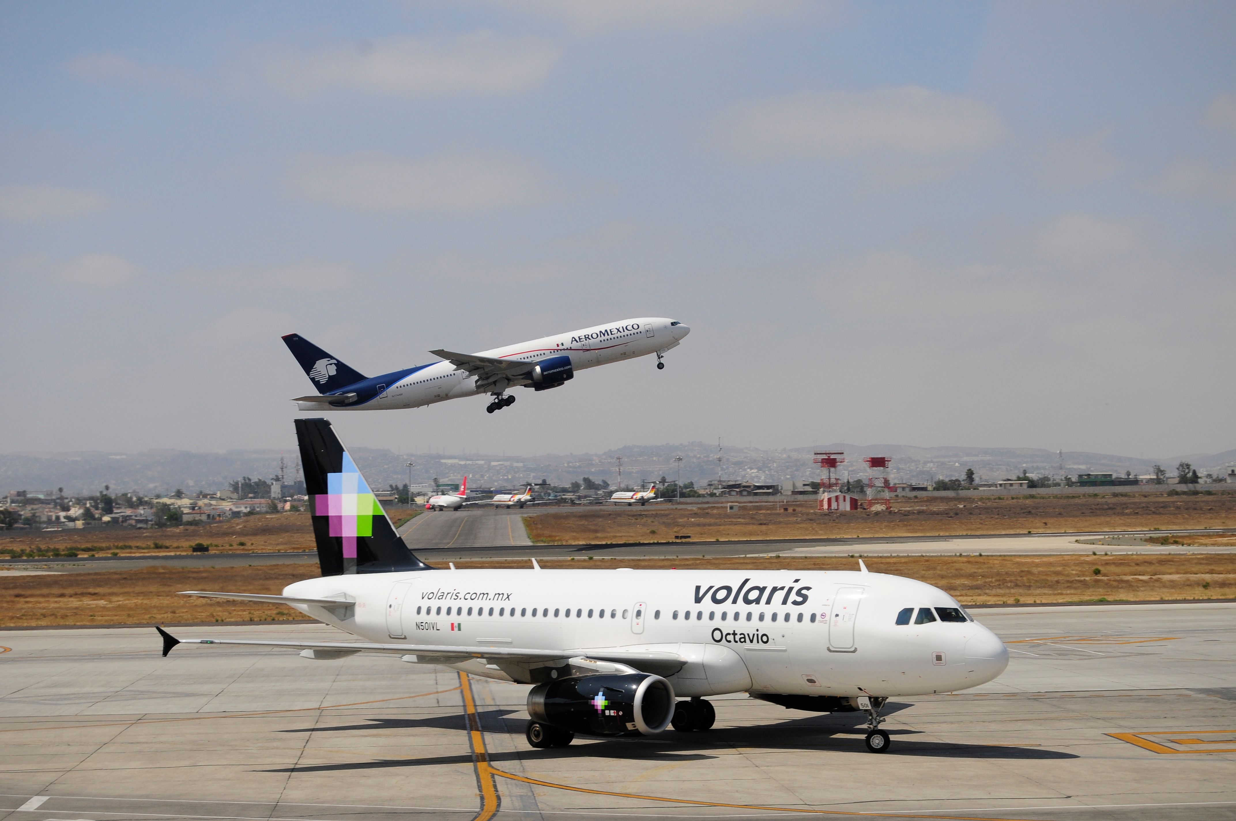 Volaris airline (on Land) and Aeromexico Airlines depart; both Mexican aircraft in the Tijuana international airport.