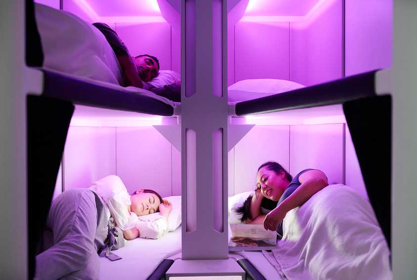 Passengers sleeping on beds part, of Air New Zealand’s Skynest economy class product.