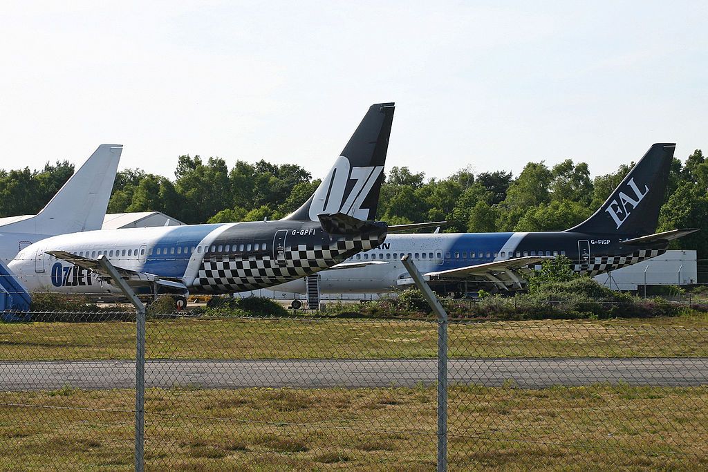 An OzJet Boeing 737-200 parked at an airfield.