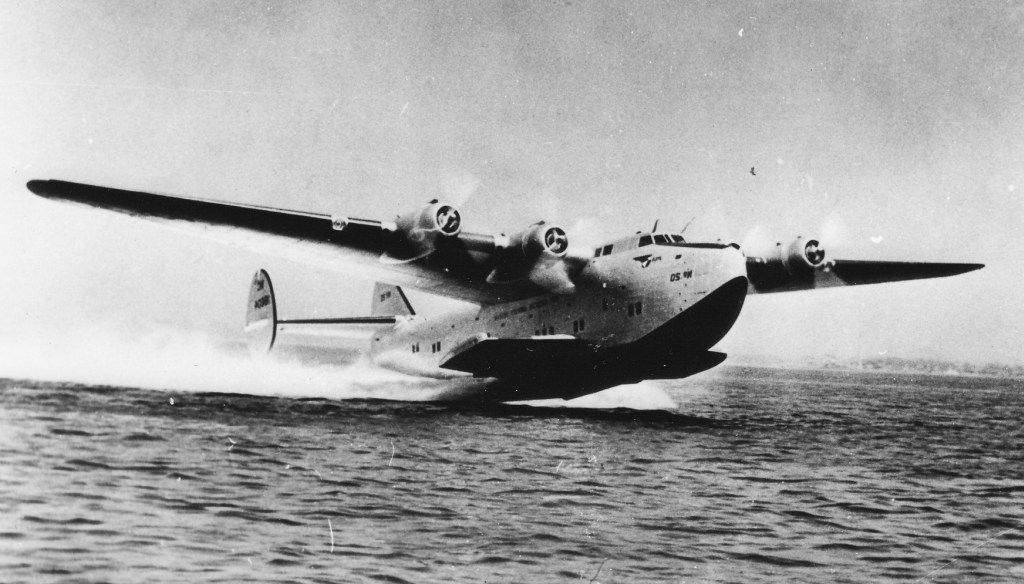 A Pan Am Boeing flying boat called the Dixie Clipper flying out of water.
