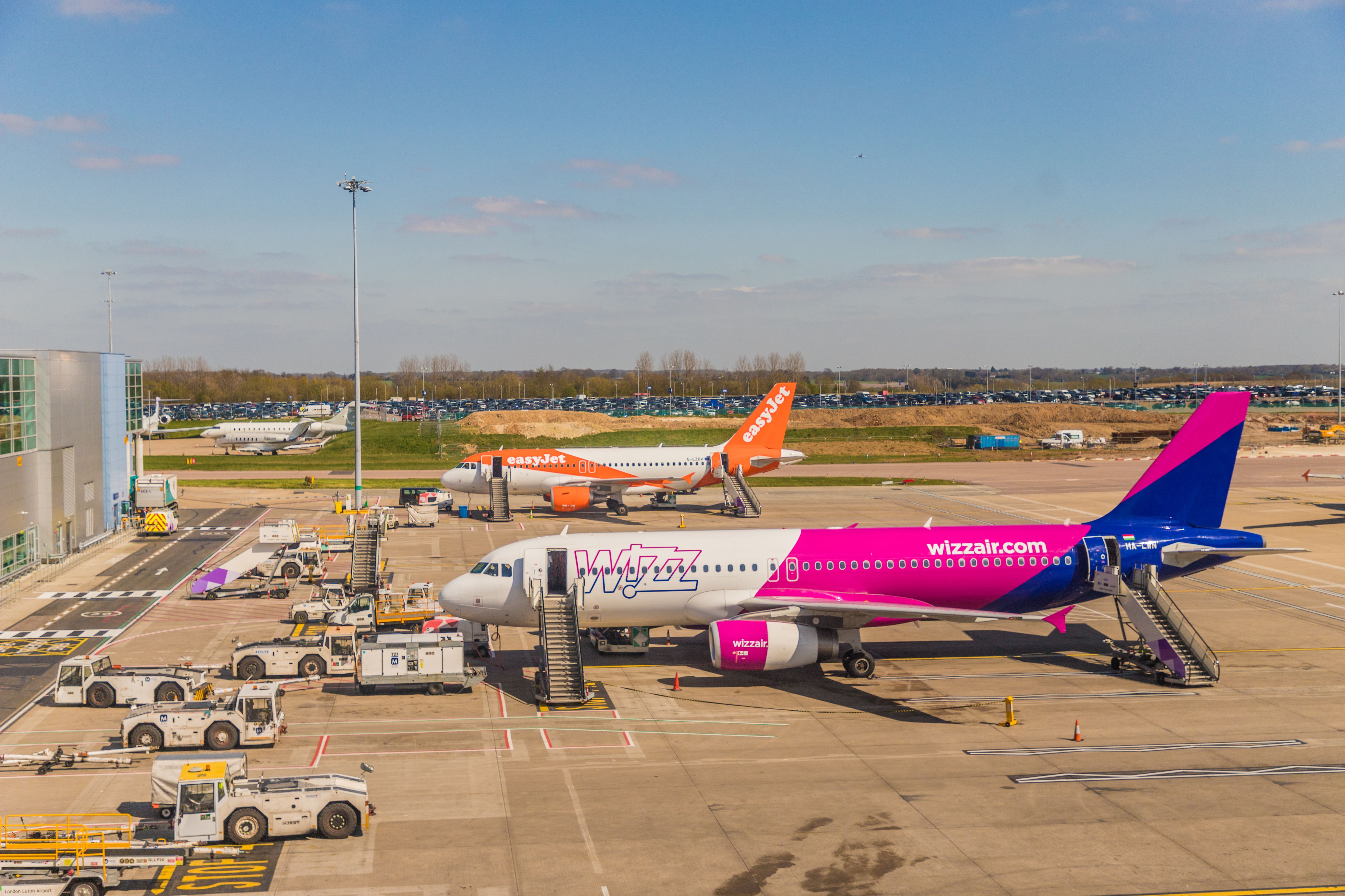 A view of an easyJet and a Wizz Air plane at Luton Airport 