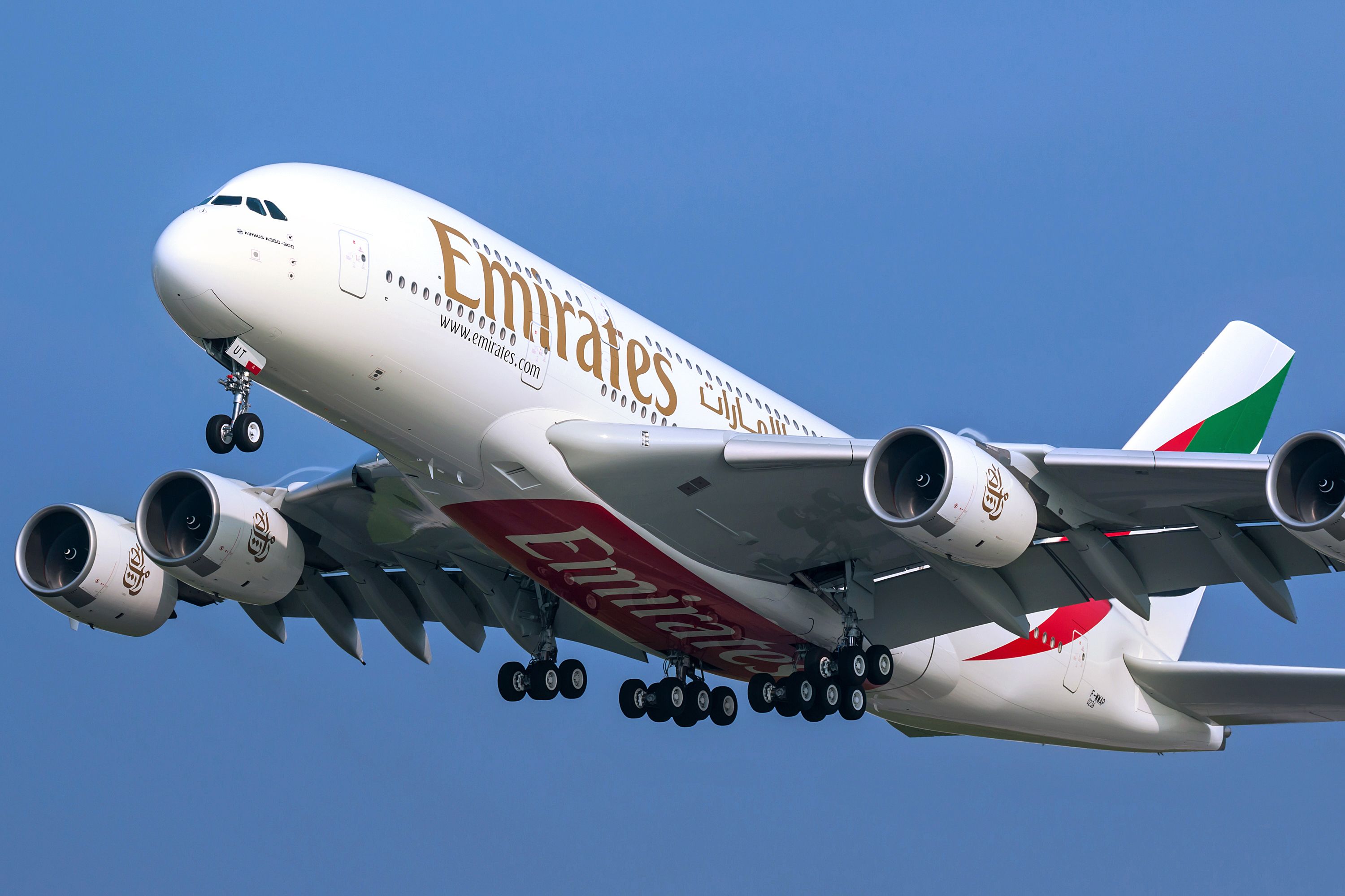An Emirates Airbus A380 flying in the sky.